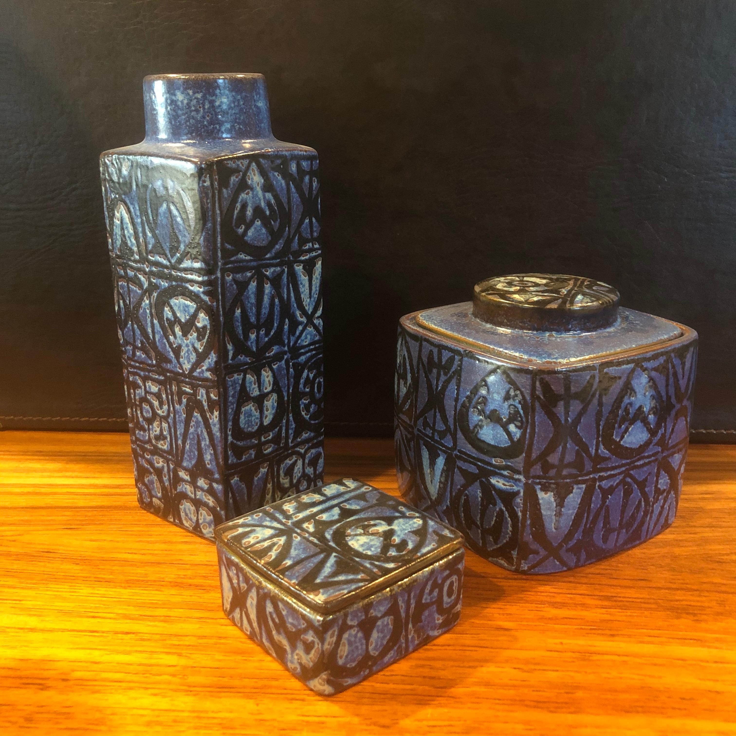 Wonderful Fajance three-piece vase, lidded box and humidor set from the Baca line by Nils Thorsson for Royal Copenhagen, circa 1960s. The stunning blue and black glazed stoneware containers with geometric abstract design was designed by Royal