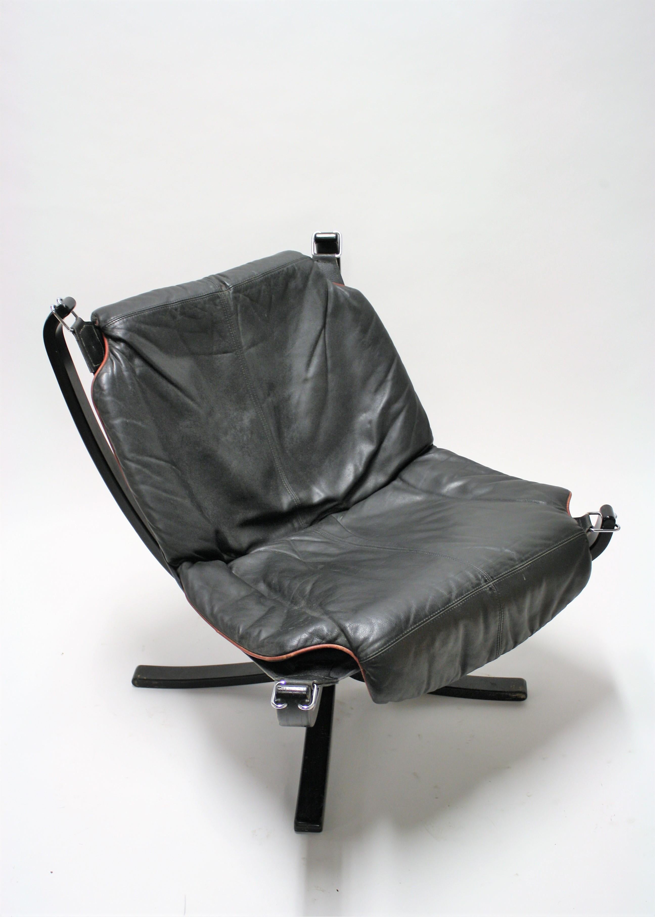 Mid-Century Modern lounge chair designed by Sigurd Ressel for Vatne Mobler.

The chair consists of a black wooden frame with black leather cushions. The cushions have a red lining.

Beautiful original condition, minor wear on the leather, no