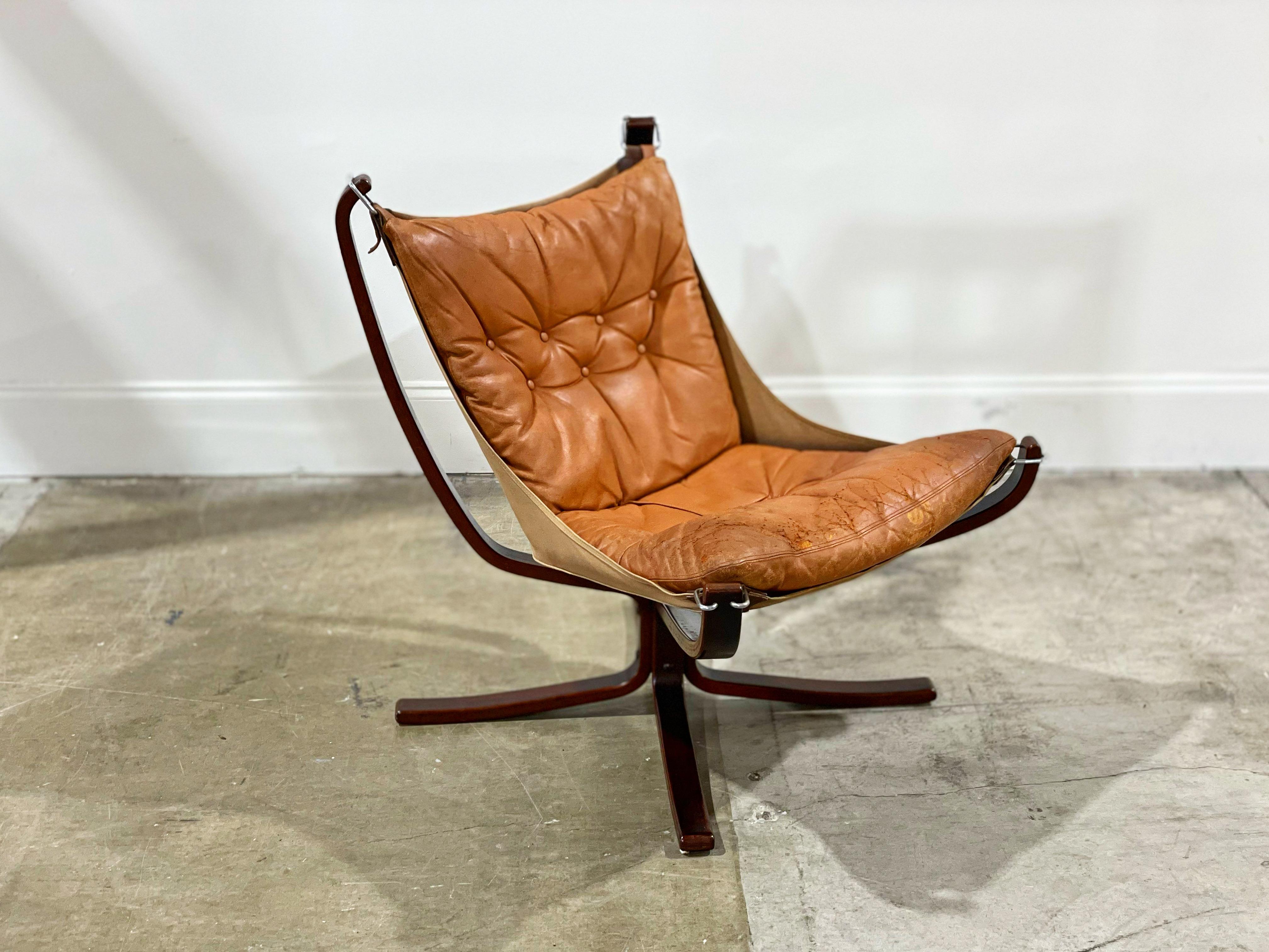 Falcon chair by Sigurd Ressell for Vatne Mobler, Sweden circa 1965. Executed in down filled leather cushions, canvas and chrome sling and a sculptural bent beechwood frame. An iconic and timeless design - it's hard to beat the silhouette and the