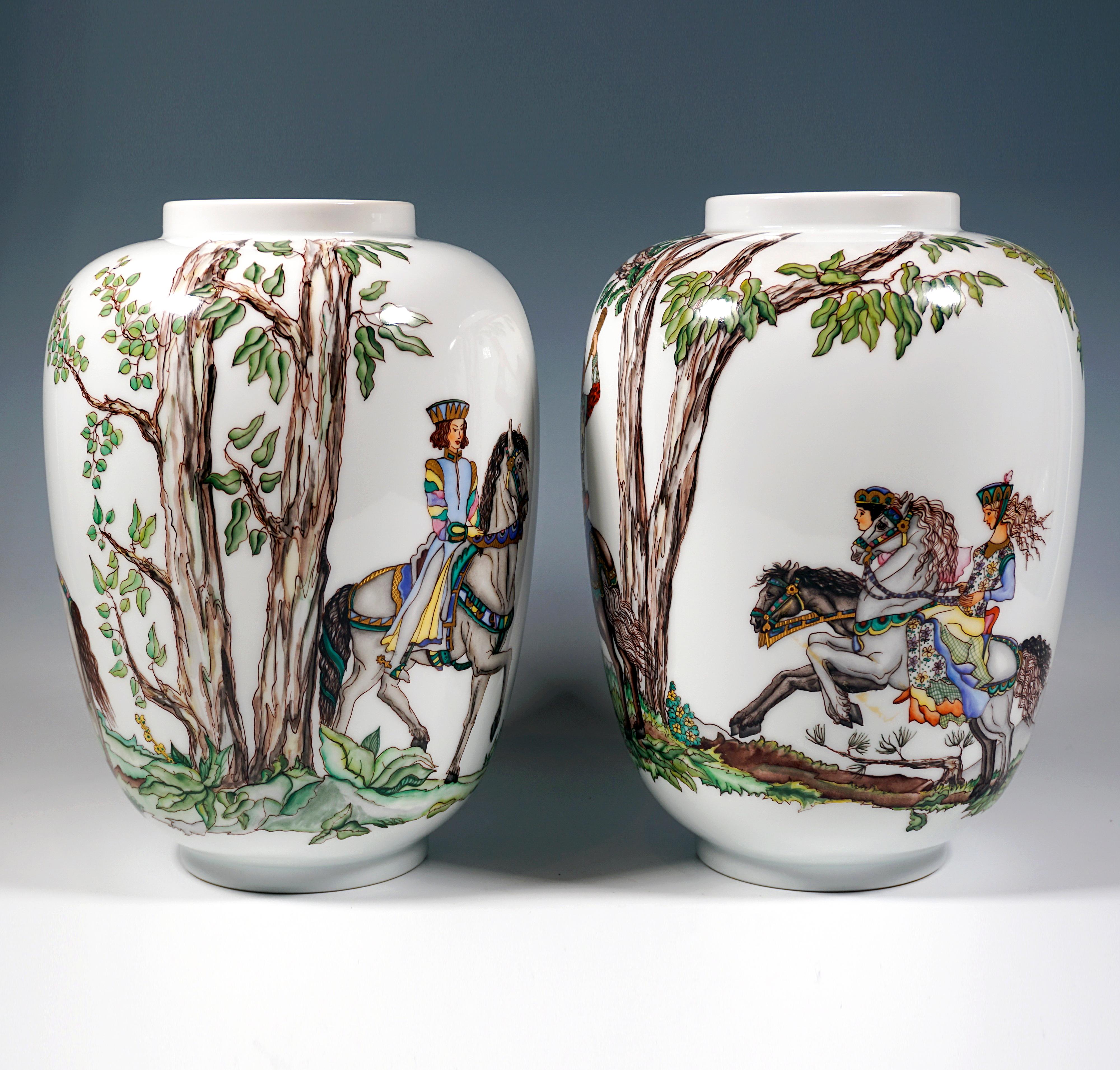 A pair of large porcelain vases with a large all-round depiction of a medieval falcon hunt on horseback in a wooded landscape against a mountainous background, noble, decorated figures on horses with elaborate harnesses painted in muted colours, a