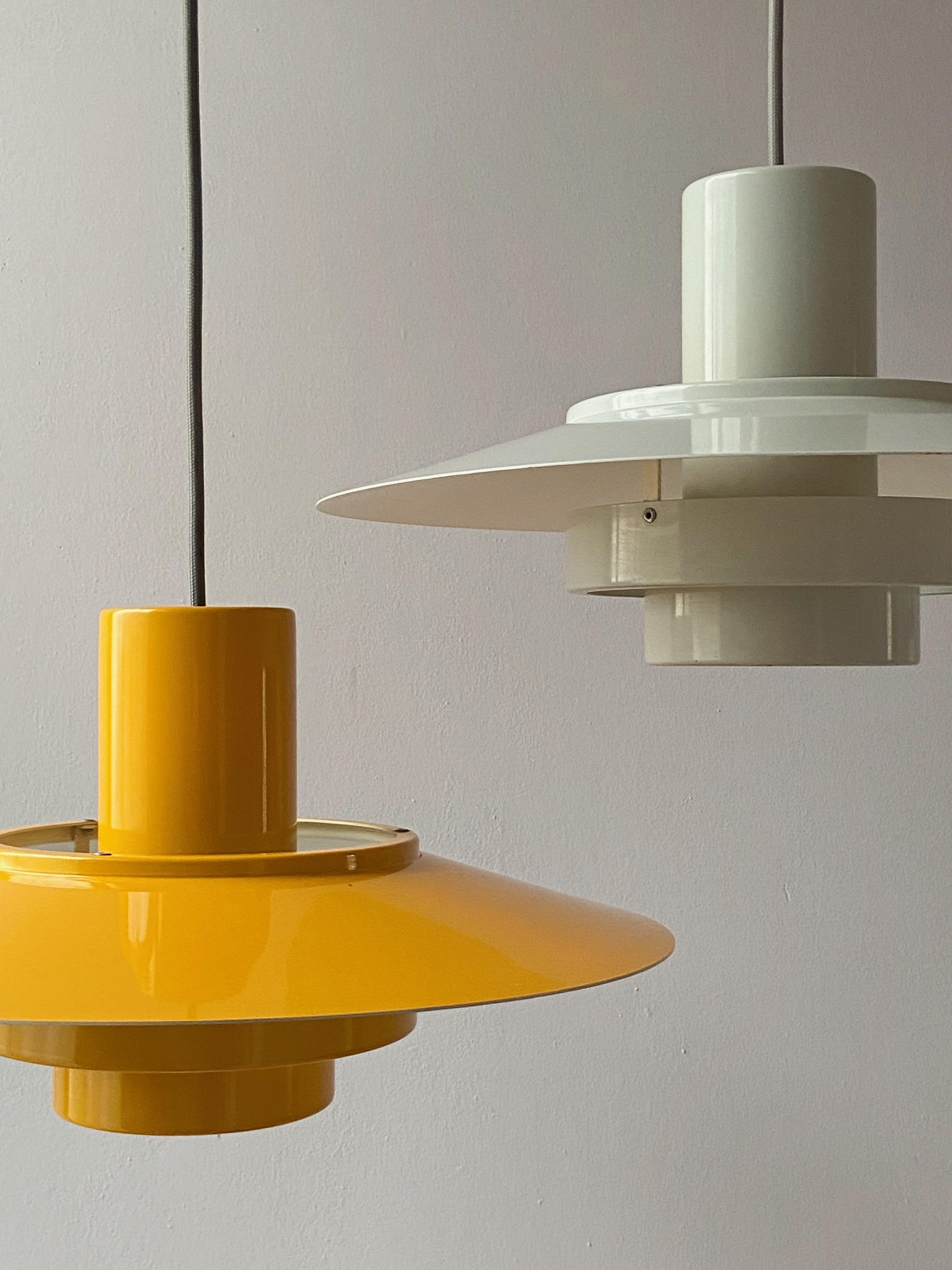 Very nice yellow pendant lamp design Andreas Hansen in 1968 produced by Fog & Mørup, Made in Denmark. The lamp is in good condition. No parts missing, with new grey fabric electric cord. 
With 1x E27 Edison screw sockets ready to use with 110 and