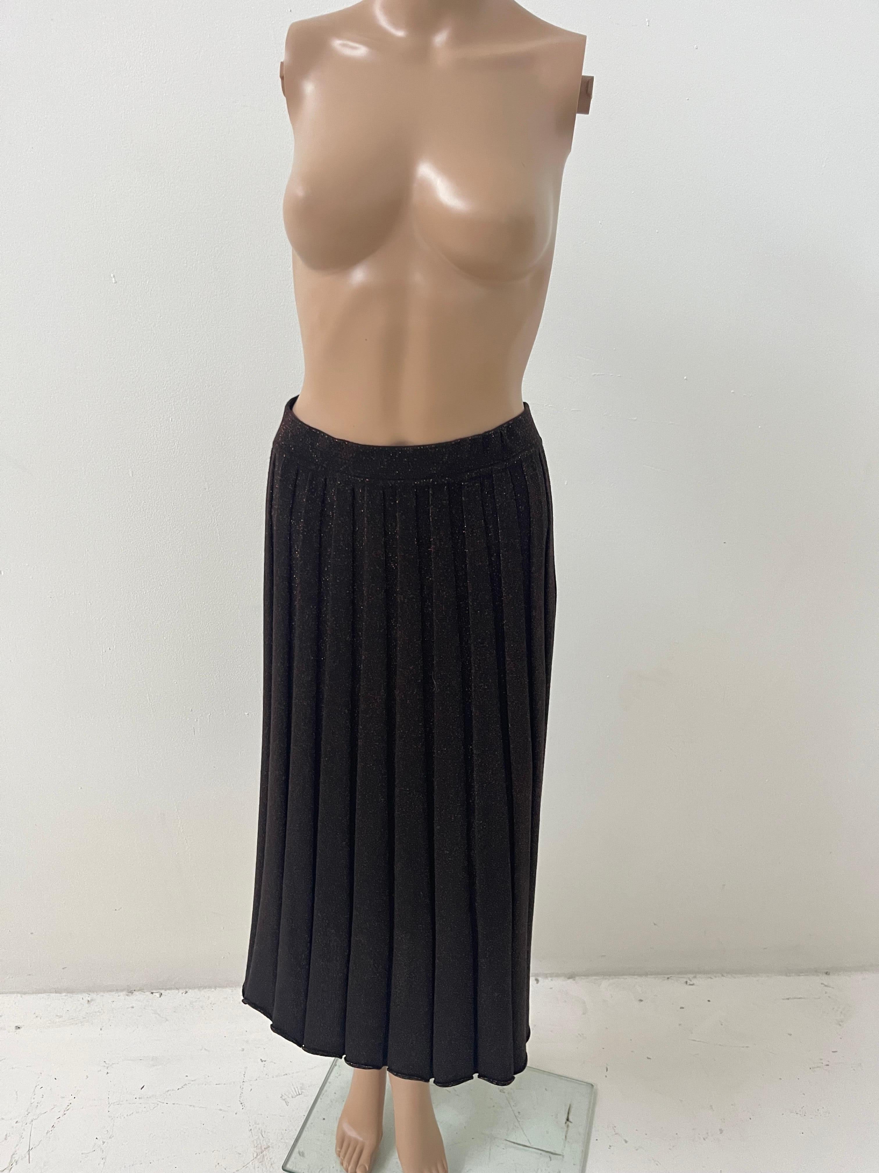 This elegant pleated long skirt by Falconeri is a refined example of Italian craftsmanship blended with a touch of understated glamour. Crafted in Italy between 2019 and 2022, this piece features a classic vertical pleat design in a high-quality