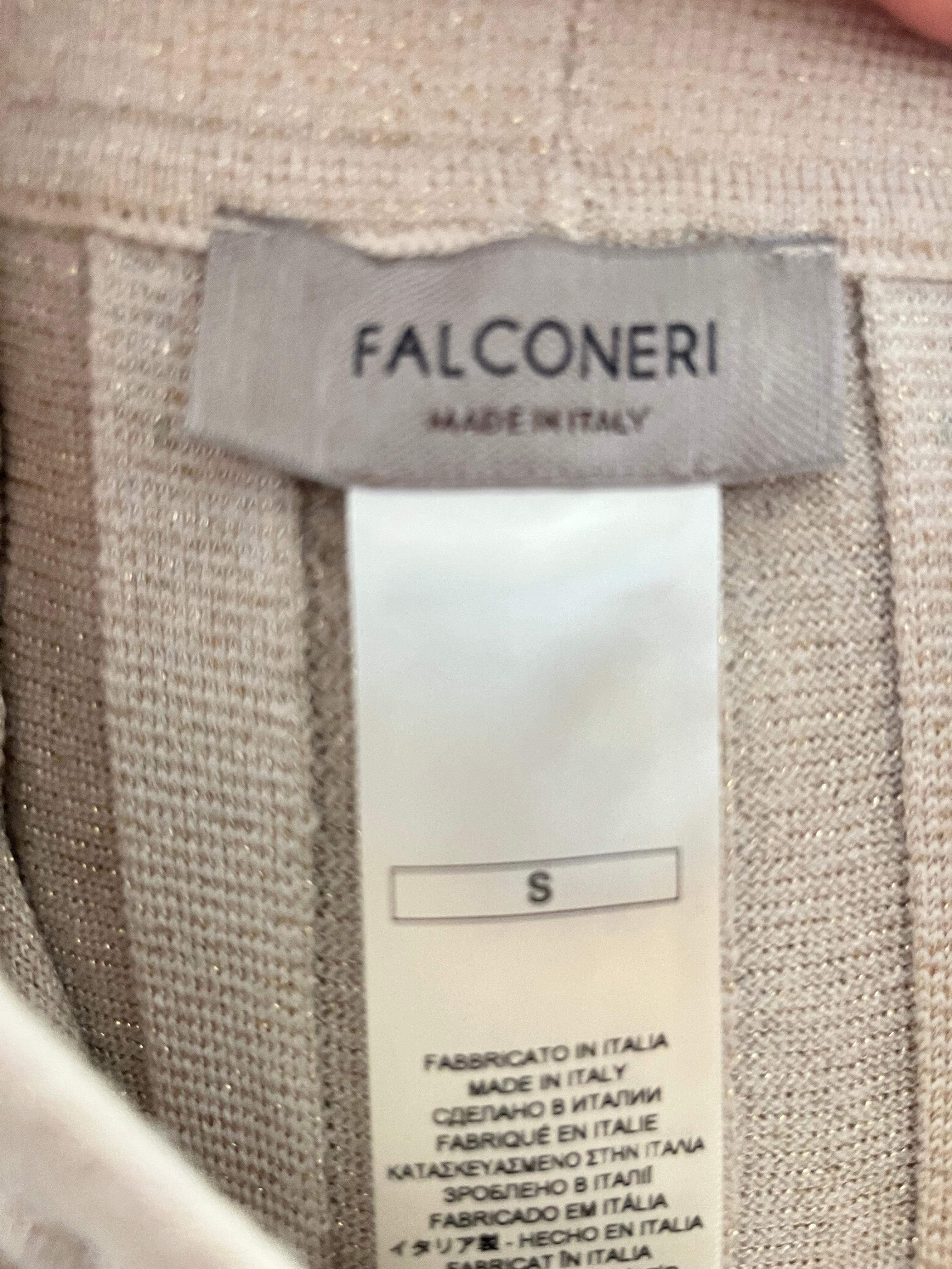 This elegant pleated skirt by Falconeri is crafted in Italy from a luxurious blend of premium yarns and infused with subtle gold lamé threads, creating a soft, sophisticated shimmer. The beige tone combined with the metallic accents gives this piece