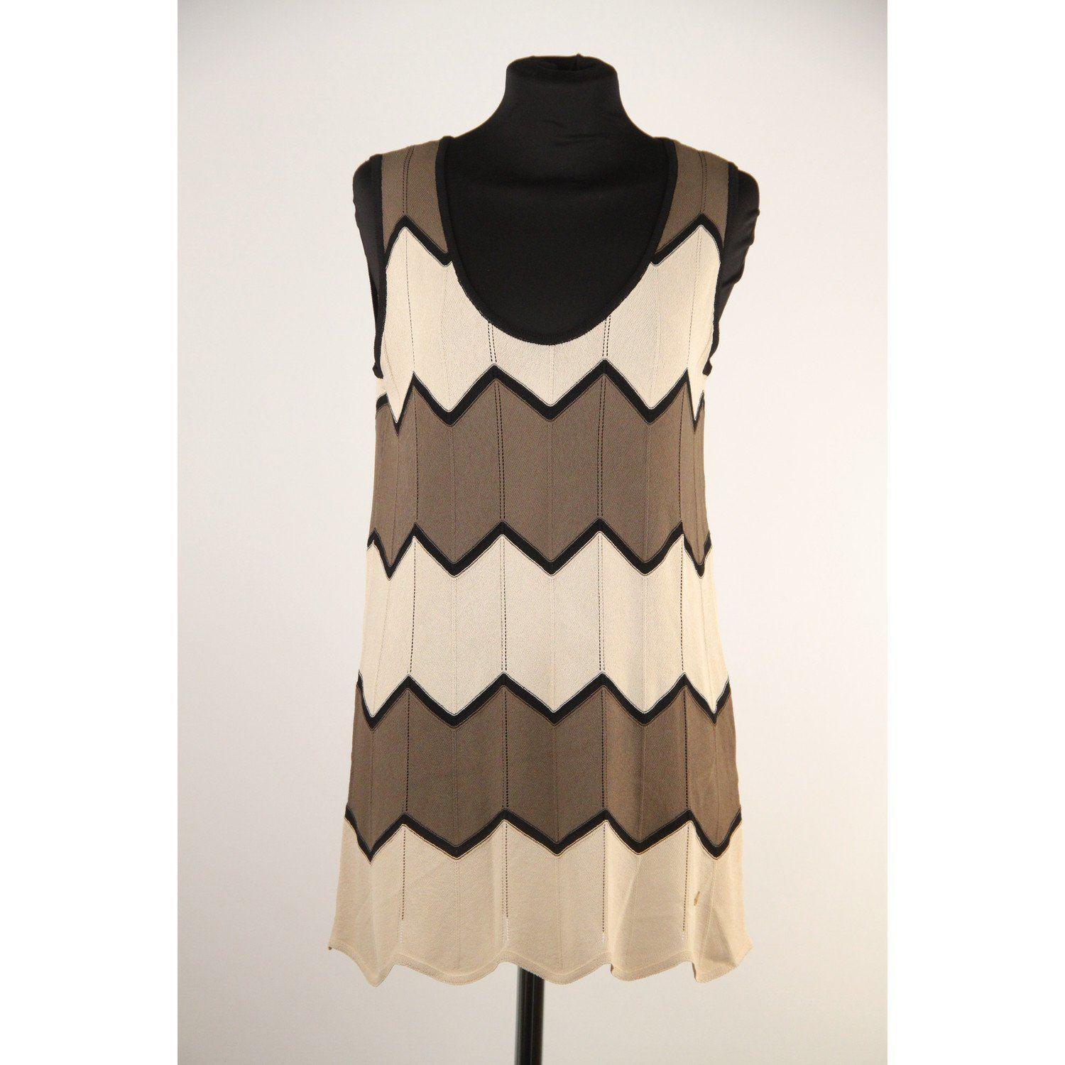 MATERIAL: Light Weight Knit COLOR: Beige, Taupe MODEL: Sleeveless Top GENDER: Women SIZE: Small CONDITION DETAILS: A+ :MINT CONDITION! Mint item. Never worn or used MEASUREMENTS: SHOULDER TO SHOULDER: 15.5 inches - 39,4 cm BUST: 18 inches - 45,7 cm
