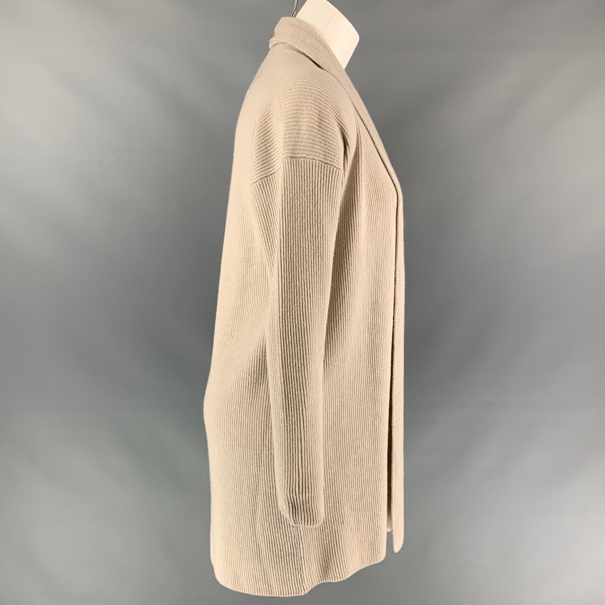 FALCONERI cardigan comes in a oatmeal ribbed cashmere featuring a shawl collar and a open front. Made in Italy.

Very Good Pre-Owned Condition.
Marked: S
Original Retail Price: $470.00

Measurements:

Shoulder: 20 in.
Bust: 40 in.
Sleeve: 21