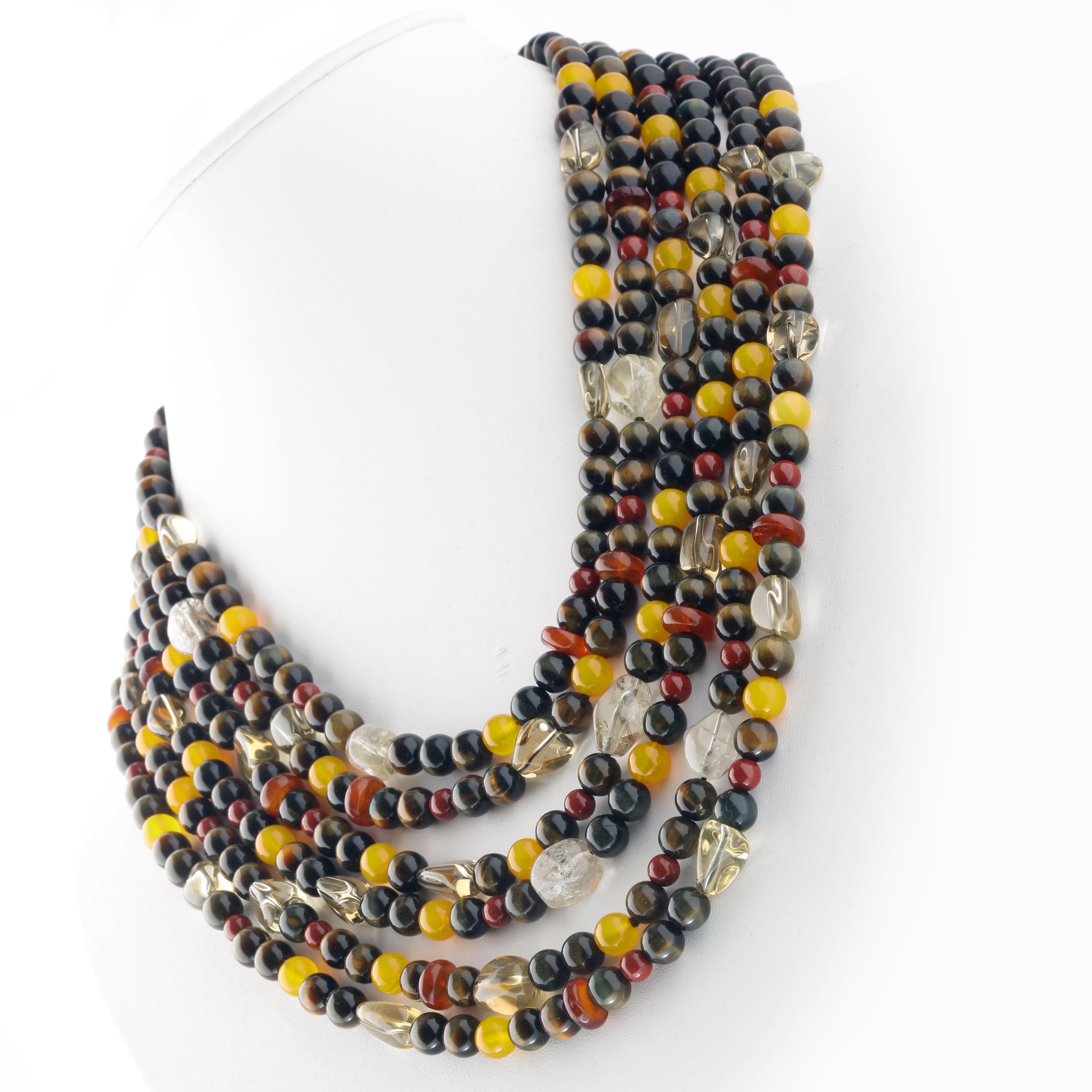 Timeless elegance for a one-of-a-kind multi-strand necklace, featuring hard and semi-precious beads of the highest quality.

• 925 sterling silver closure
• Beads utilised: Falcon's Eye, Yellow Agate, Red Jasper, Lemon Citrine, Amber Rondelles
•