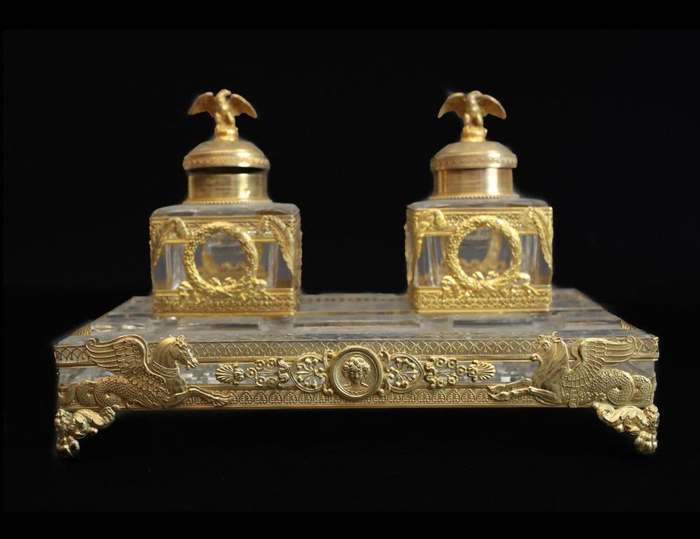 An outstanding 2nd Empire French gilt .950 silver and cut-crystal encrier with dual inkwells retailed by Falize. The lids with eagle finials, the reticulated border cast with a Pegasus and winged bull, encircled with a portrait medallion, sitting