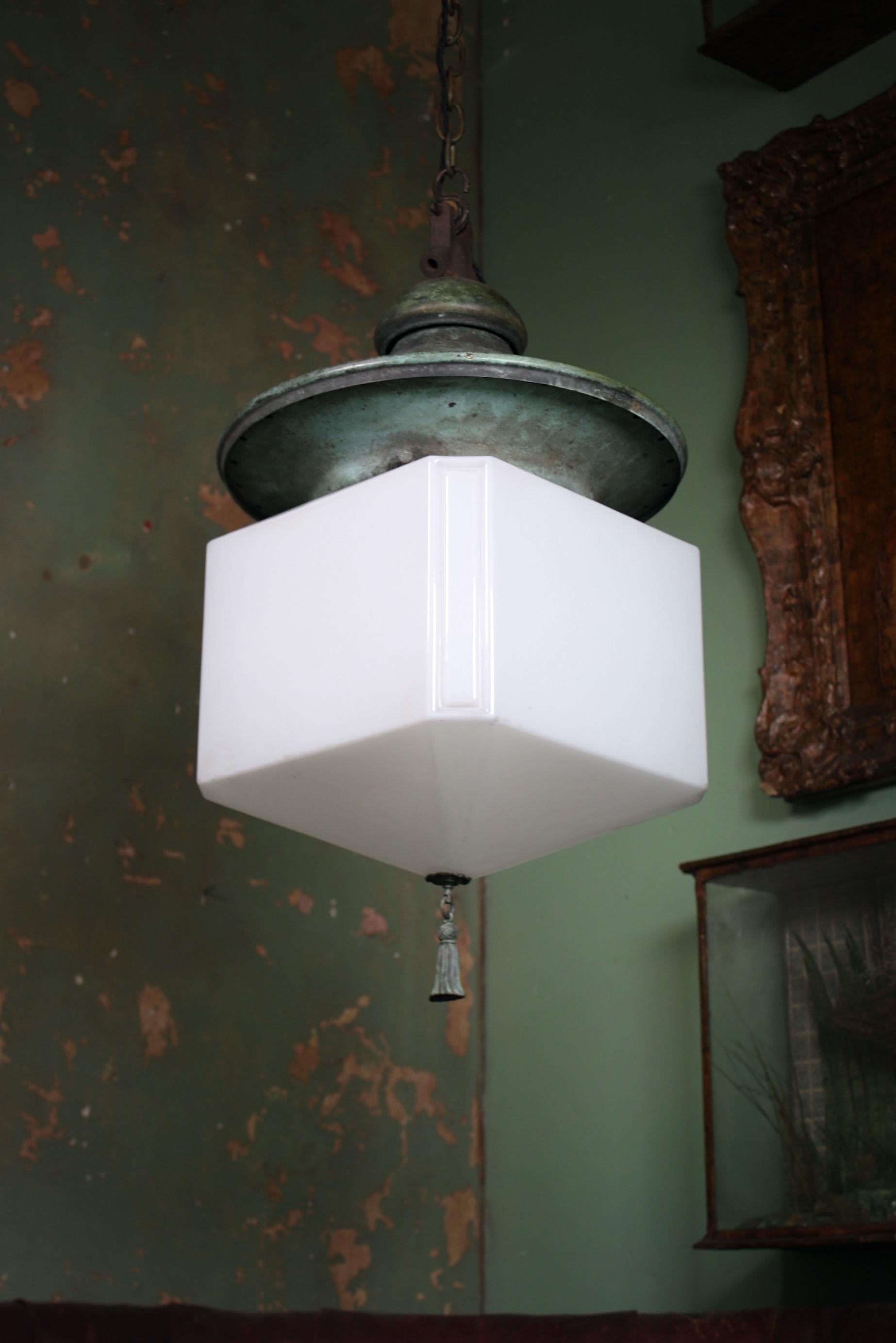 An oversized opaline and copper pendant, with the most wonderful natural verdigris patina.

The very well proportioned gallery with a shapely pagoda hood, holds the cube opaline shade that terminates with a copper tassel, all metal section has age