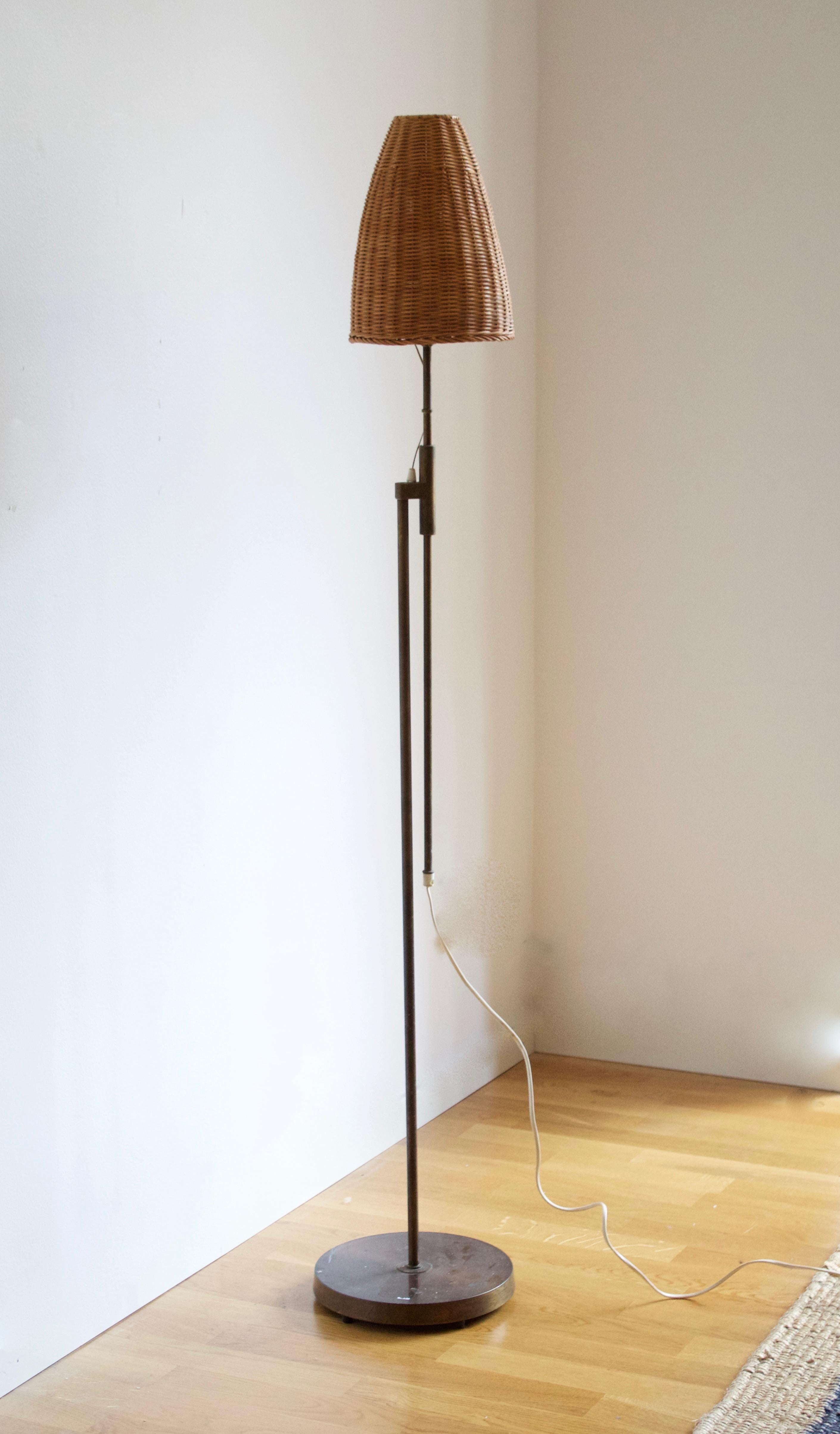An adjustable floor lamp. Produced by Falkenbergs Belysning. Stamped

With an assorted vintage rattan lampshade.

Other designers of the period include Hans Bergström, Hans-Agne Jacobson, Alvar Aalto, Josef Frank, and Paavo Tynell.