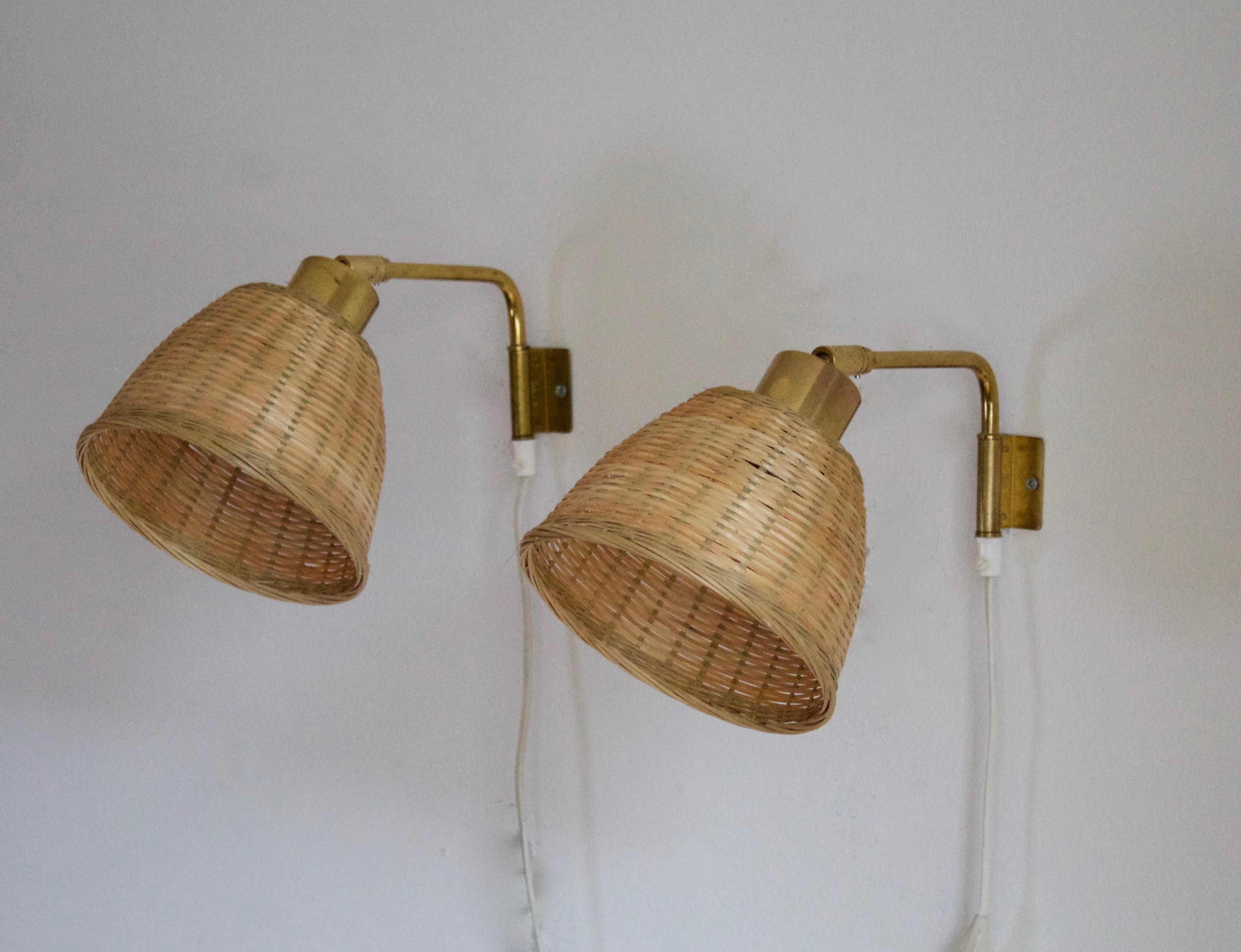 A pair of adjustable wall lights. Produced by Falkenbergs Belysning. Marked. With assorted vintage rattan lampshades.

Stated dimensions include attached lampshades.

Other designers of the period include Hans Bergström, Hans-Agne Jacobson,