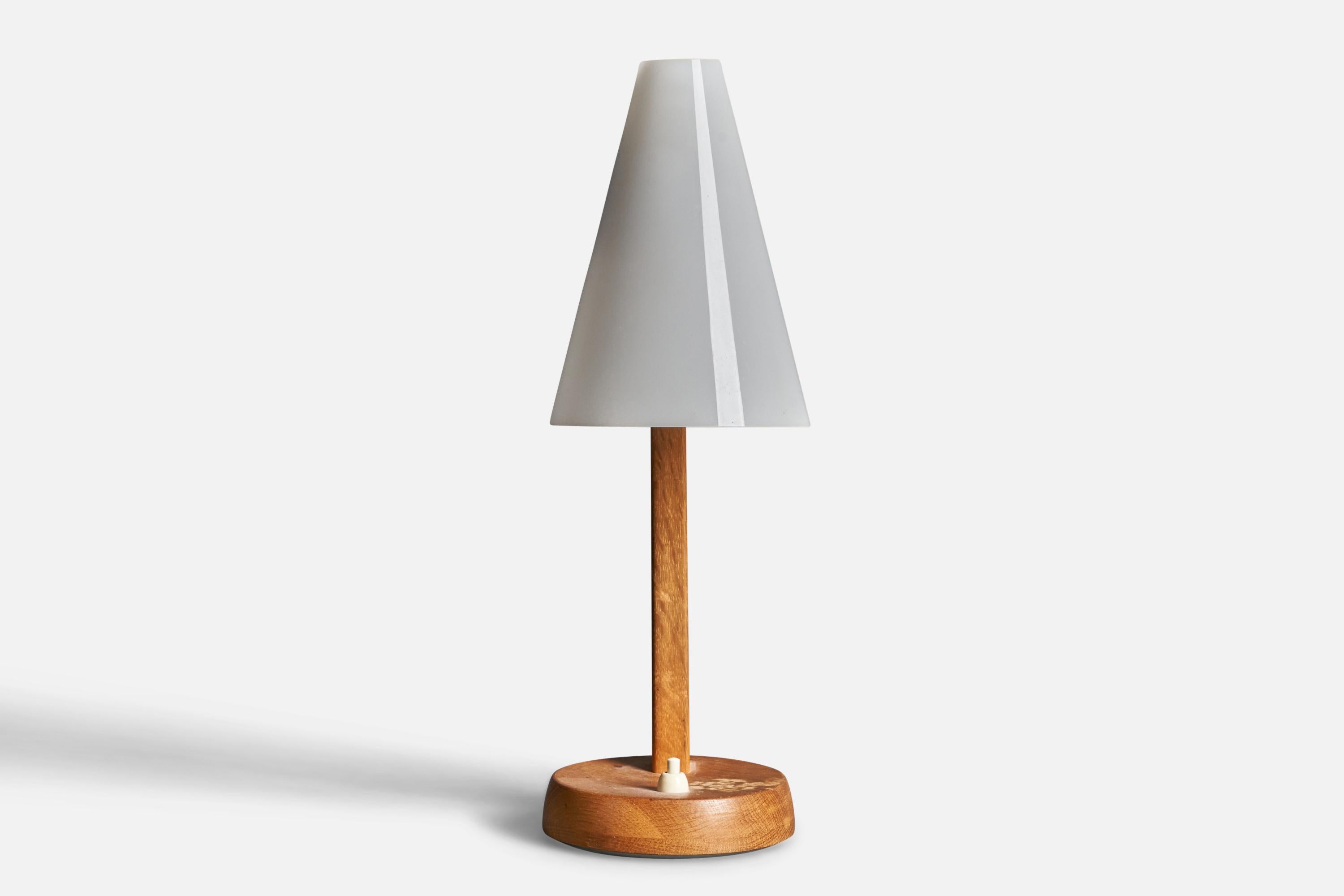 An adjustable table lamp or desk light. Produced by Falkenbergs Belysning. Stamped. In solid oak, brass details, acrylic lampshade.

Other designers of the period include Hans Bergström, Hans-Agne Jacobson, Alvar Aalto, Josef Frank, and Paavo