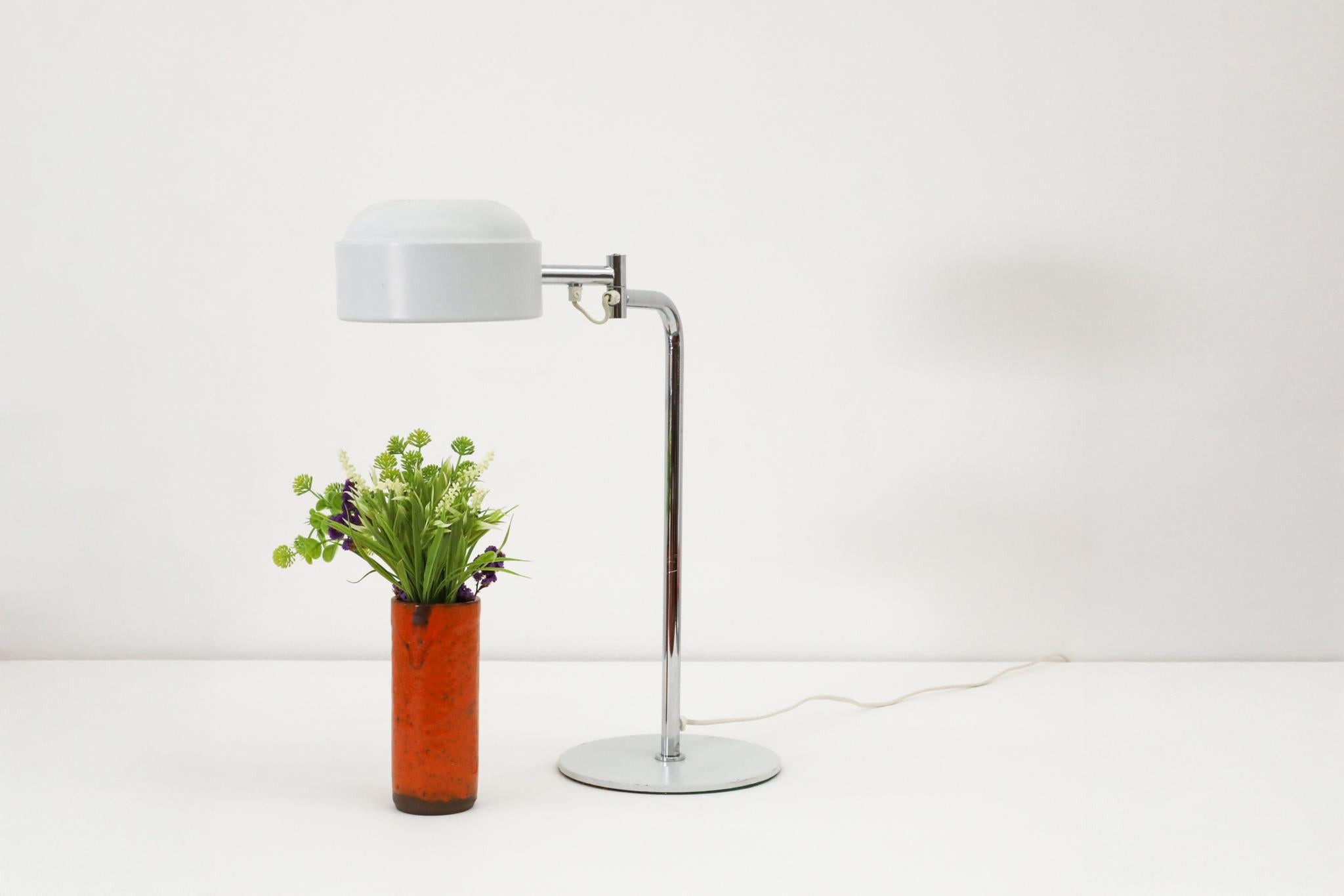 Swedish Mid-Century, Falkenbergs Belysning manufactured articulating table/task lamp with a pill box-shaped gray enameled shade and a gray enameled base mounted on a chrome stem. The light uses a (75W max) medium size bulbs. In total there are 4