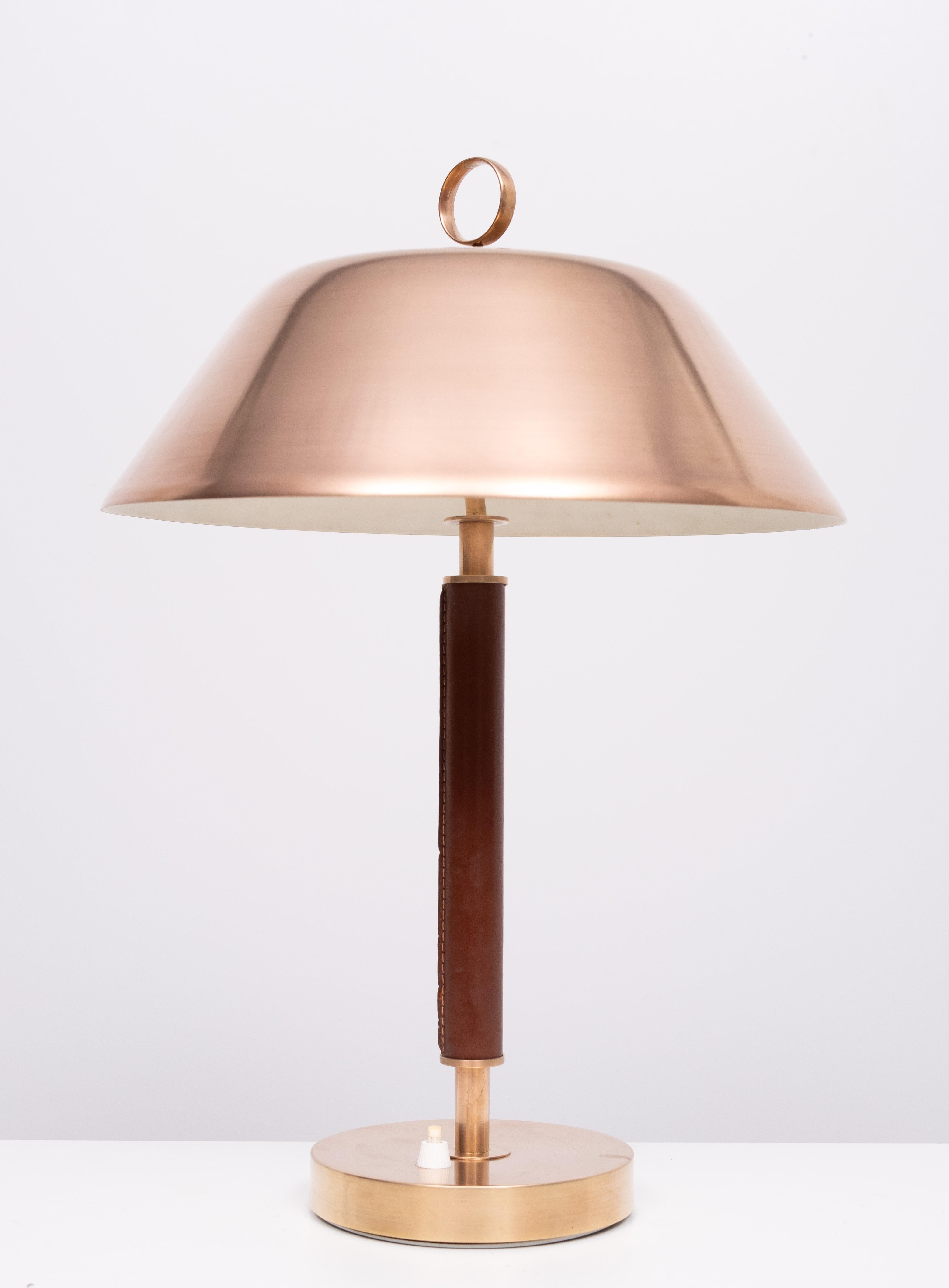 Beautiful stylish Brass and stich Leather table lamp .  Solid Brass   
shade . Manufactured By Falkenbergs Belysning  Sweden 1960 .
Top quality firm . Time less design . 