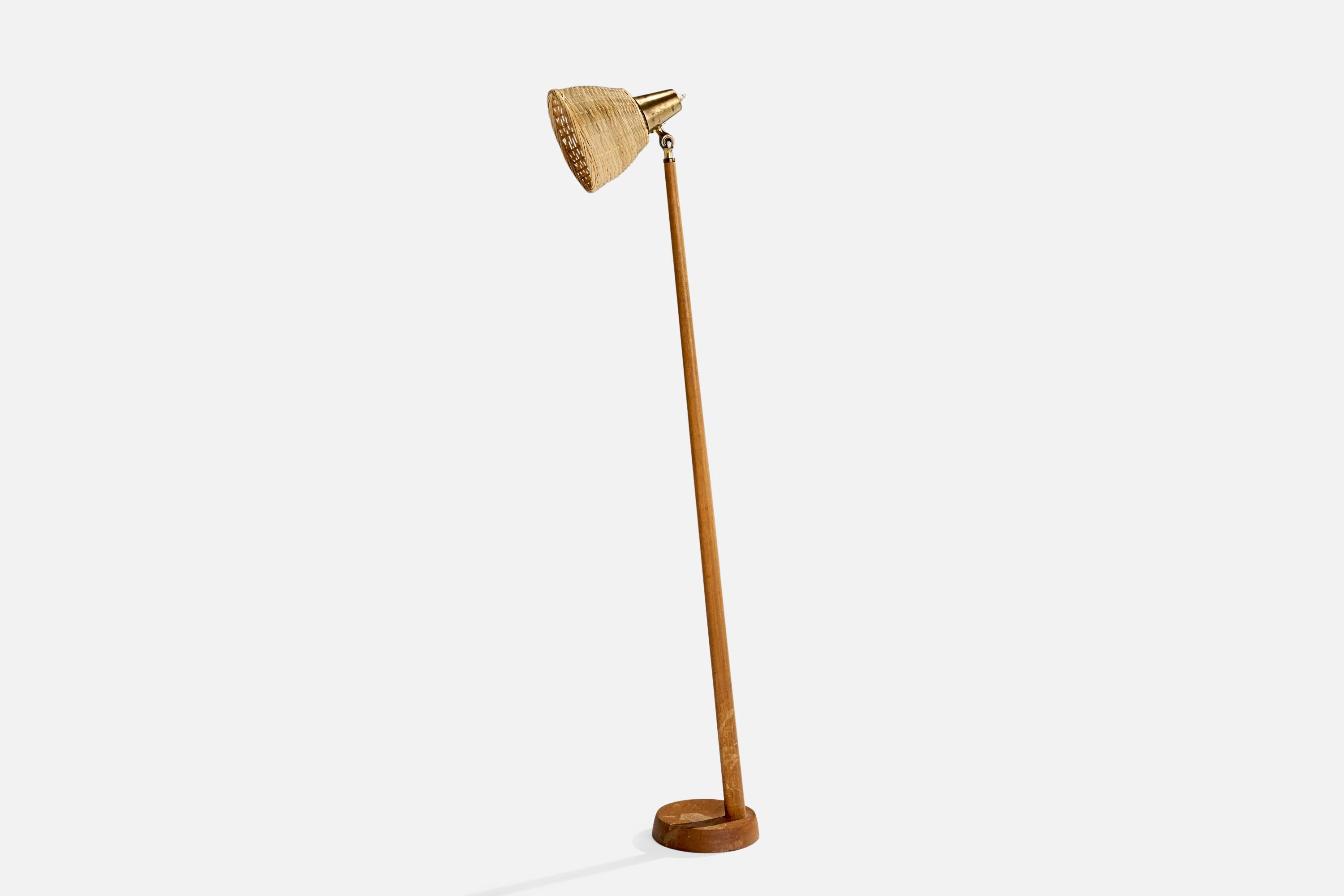 An adjustable brass, oak and rattan floor lamp designed and produced by Falkenbergs Belysning, Sweden, 1960s.

Overall Dimensions (inches): 49.22”  H x 6.7” W x 14.57”  D
Stated dimensions include shade.
Bulb Specifications: E-26 Bulb
Number of