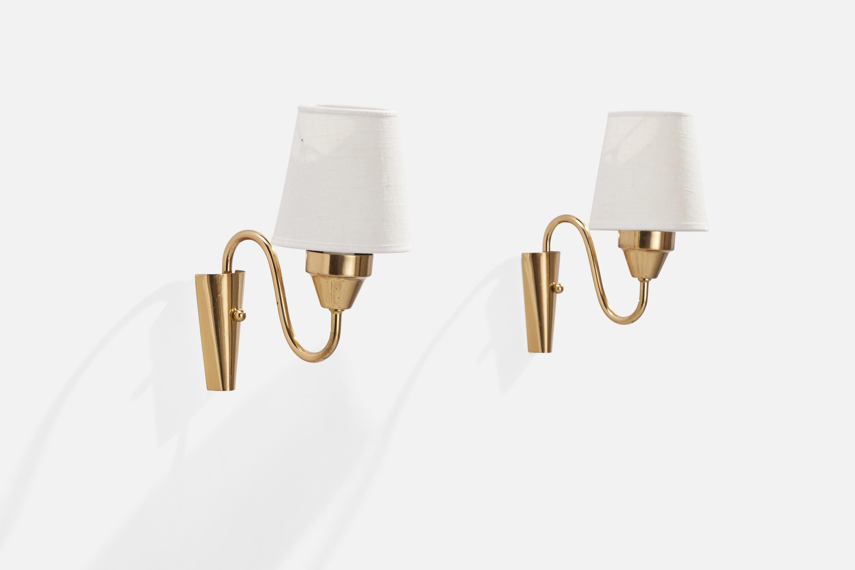 A pair of brass and white fabric wall lights designed and produced by Falkenbergs Belysning, Sweden, 1960s.

Overall Dimensions (inches): 5”  H x 2”  W x 5.50”  D
Back Plate Dimensions (inches): 3.5”  H x 1.75” W x .75” D
Bulb Specifications: E-14