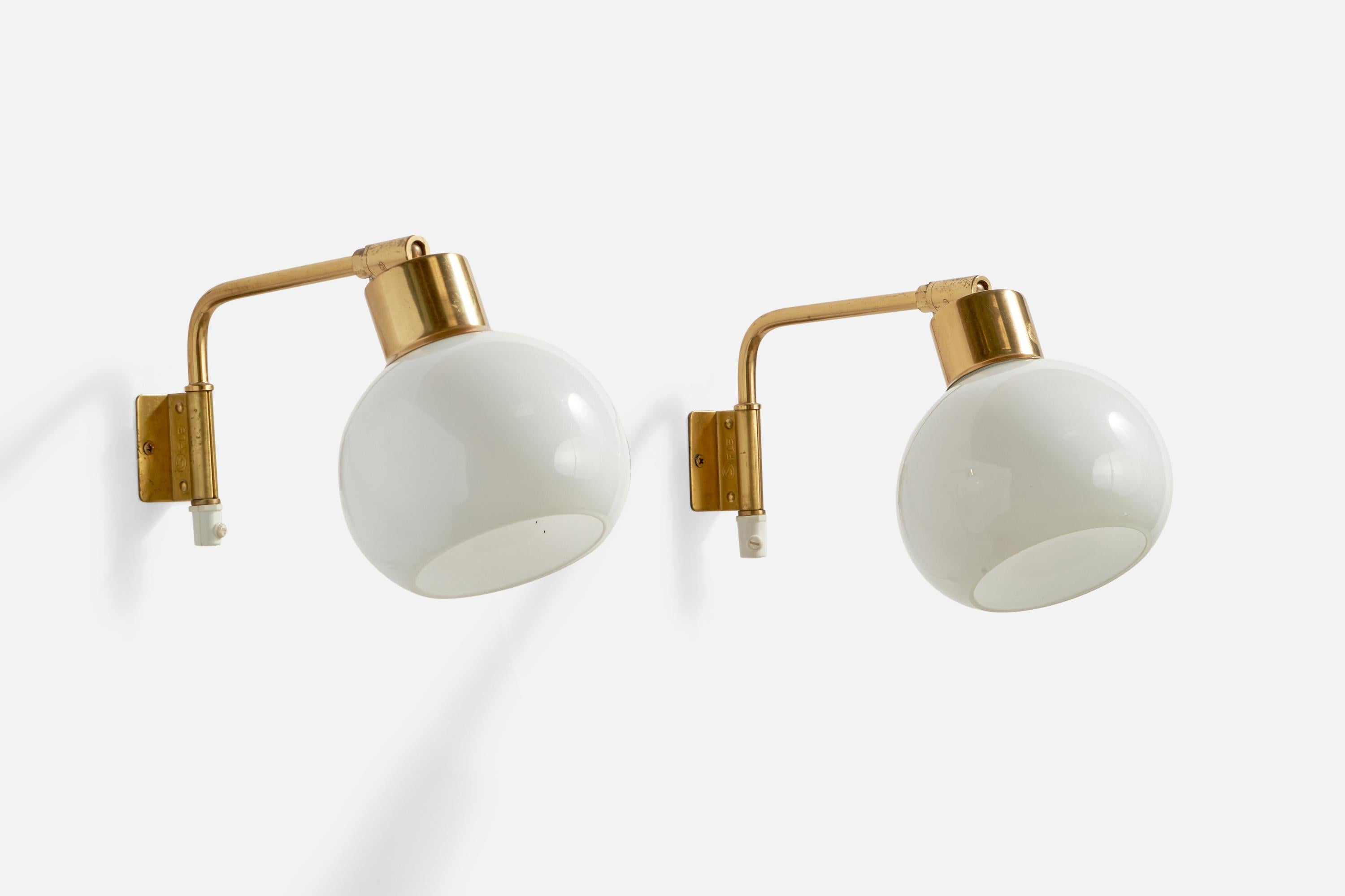A pair of adjustable brass and opaline glass wall lights designed and produced by Falkenbergs Belysning, Sweden, 1960s.

Overall Dimensions (inches): 6.35” H x 5.1” W x 9.8” D
Back Plate Dimensions (inches): 2” H x 1.65” W x 0.6” D
Bulb