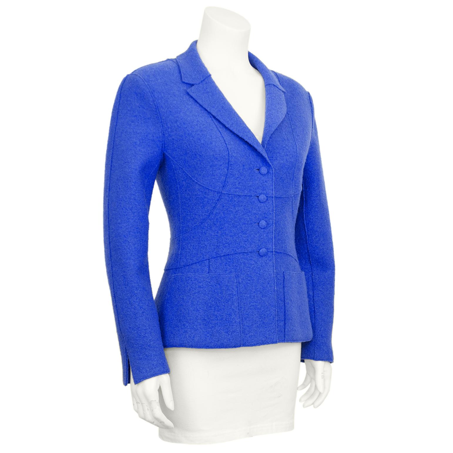 Chanel Fall 1999 collection periwinkle blue felted wool jacket. The seams are bonded and the buttons are covered in the same blue wool fabric. The seams are curved to accentuate the waist with a slightly flared hem. Notched collar and two front