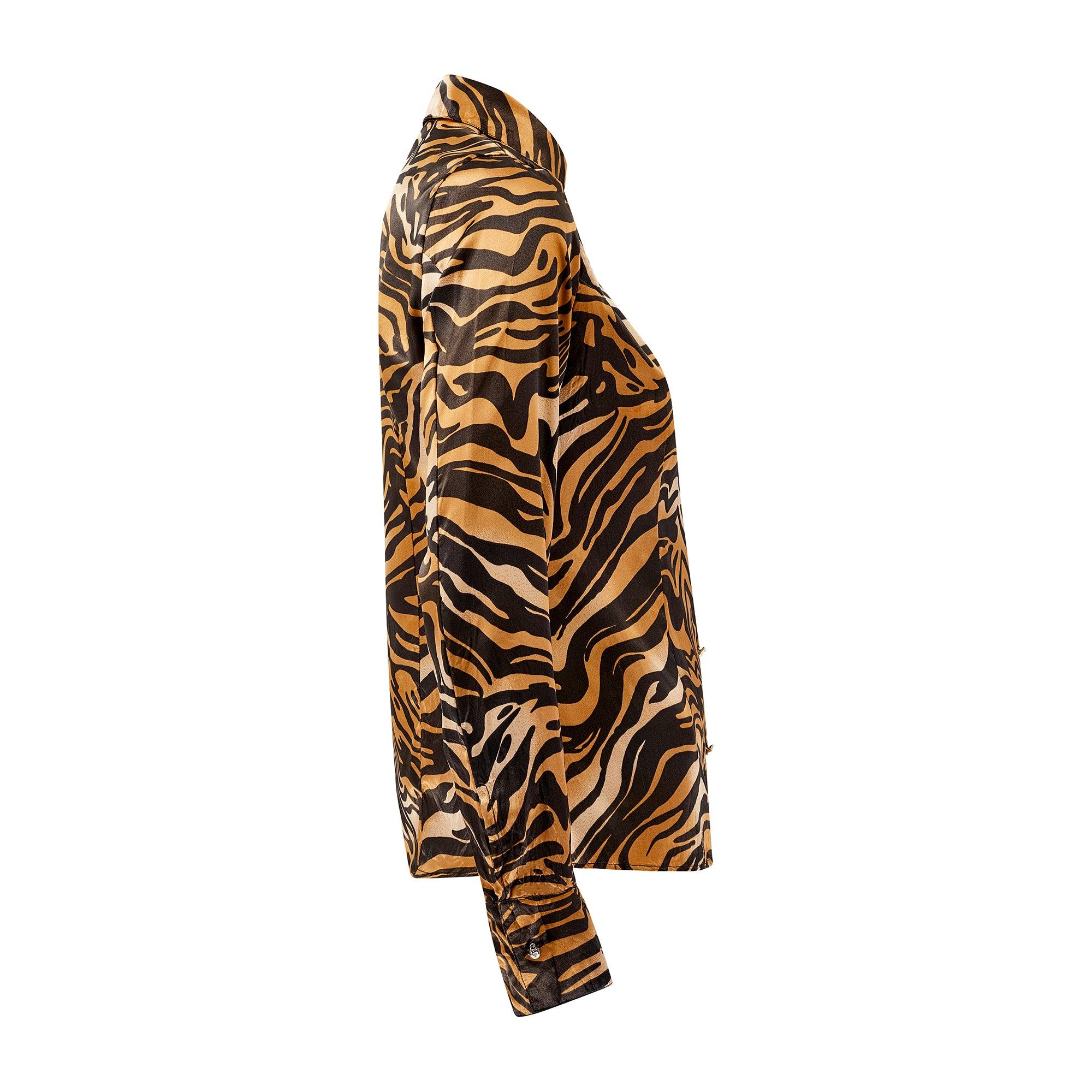 This tiger print Roberto Cavalli shirt dates back to the Italian designer's heyday and is from the Fall 2000 collection. Much sought-after today, this piece showcases the brand's signature animal print all-over. True to form, this sensuous shirt is