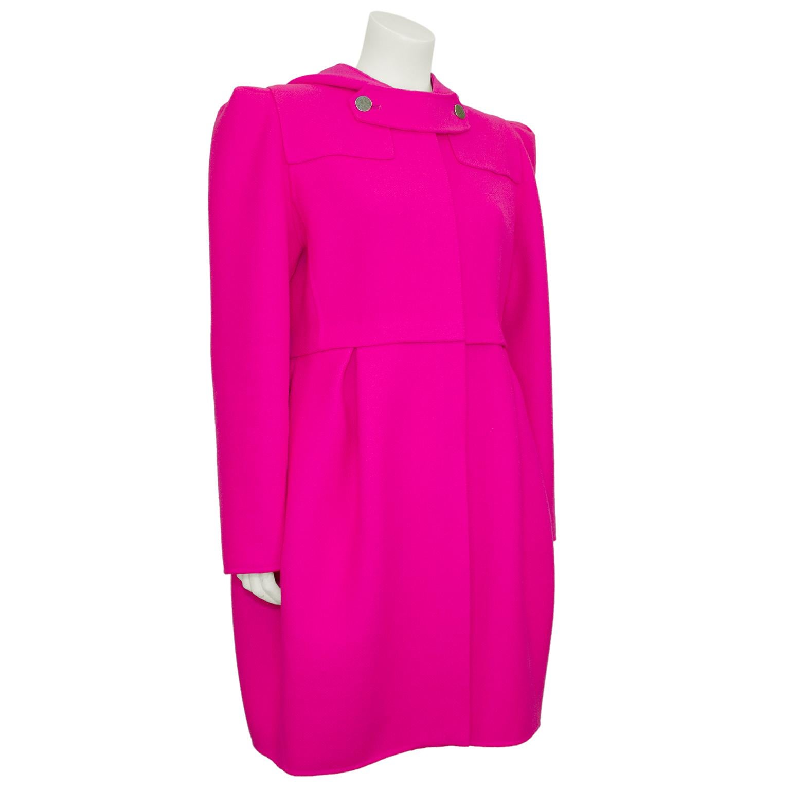 Stunning bright fuchsia Marc Jacobs felted wool coat from the fall 2009 runway collection. Features a handkerchief shaped hood and two round silver metal buttons at yoke. Heavy duty covered silver zipper up centre front. Slightly cinches at waist