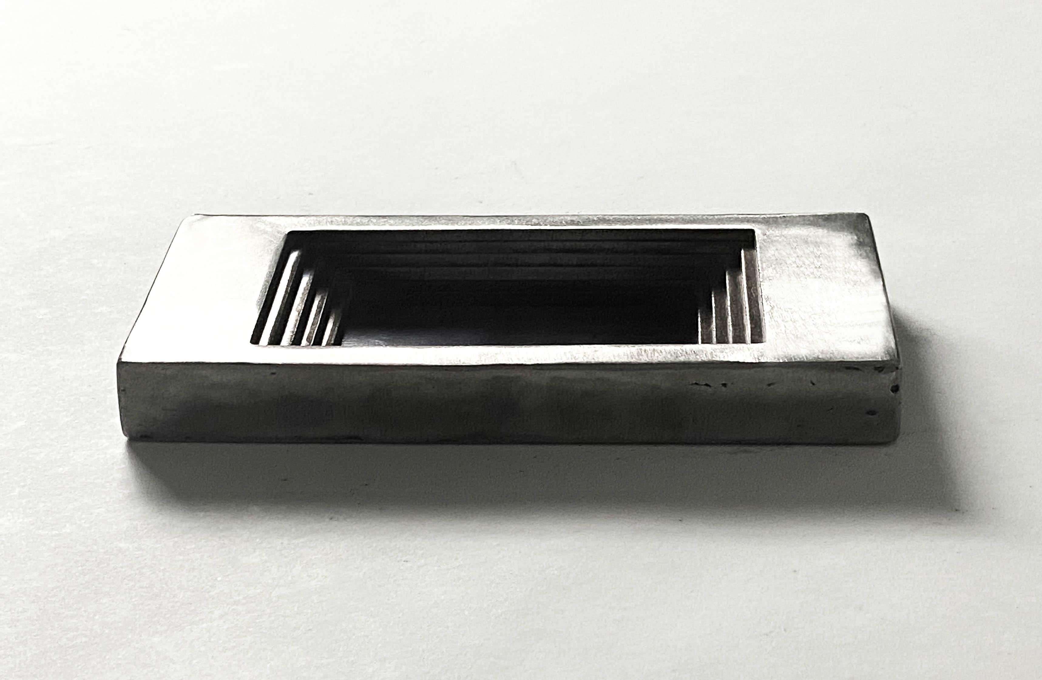 Fall Regular Ashtray by Cal Summers
Dimension:  D 6.8 x W 15 x H 2 cm
Materials: Stainless Steel.

Cal Summers is a British designer who makes bespoke handmade furniture and contemporary artefacts in which he challenges the boundaries of materiality