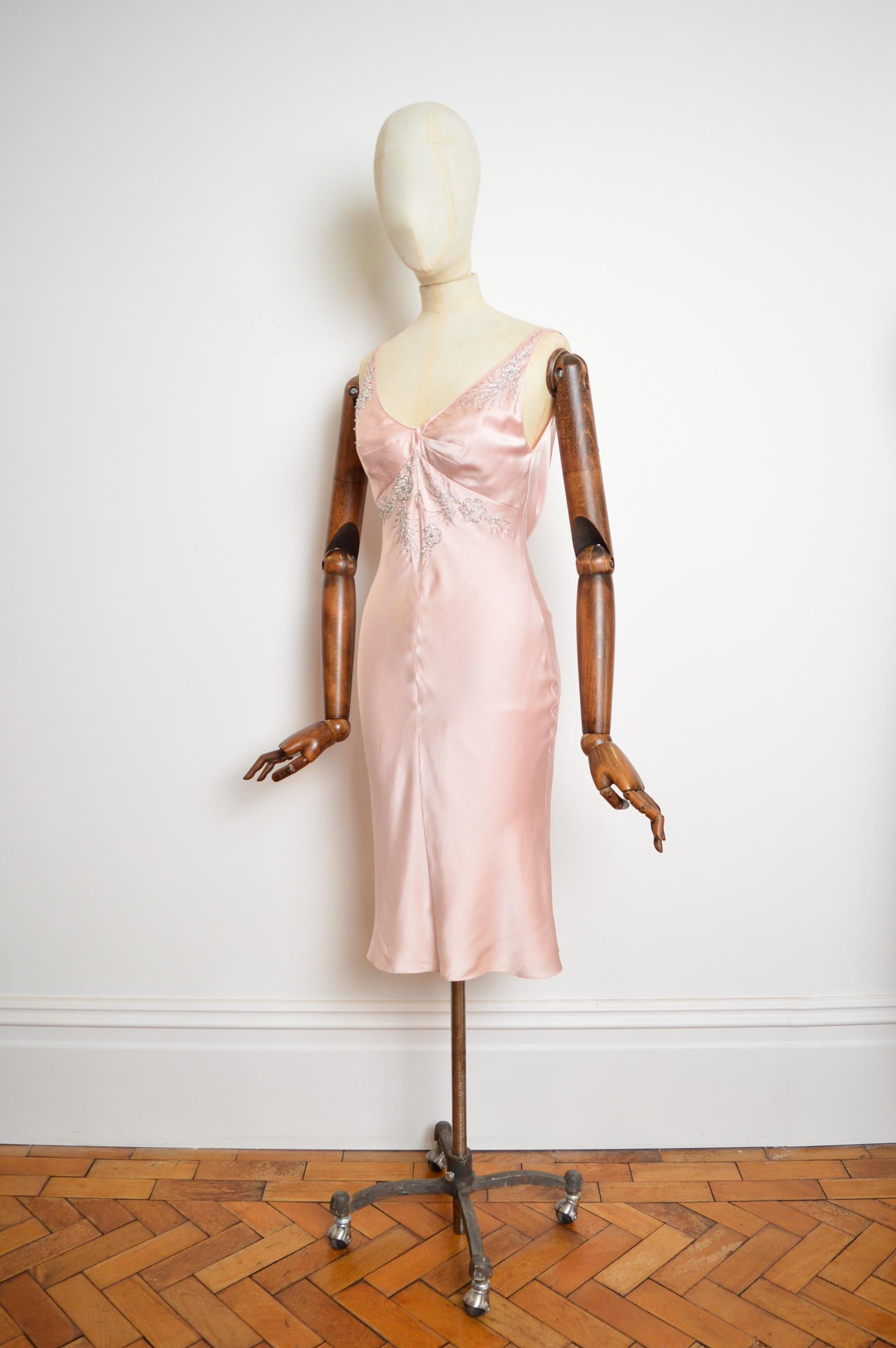 This Beautiful, ballet pink pure silk cocktail dress for Christian Dior's Autumn / Winter 2004 Collection designed by John Galliano, features a superb bias cut figure-skimming silhouette, intricately hand embroidered glass bead detailing, cinched