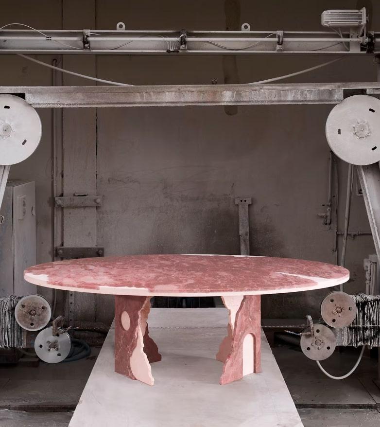 The Fallen Empire dining table is part of a striking collection consisting of four pieces—a round coffee table, a side table, a console, and a dining table—each meticulously crafted from the finest marbles. Featuring Verde Alpi, Rosa Peralba,