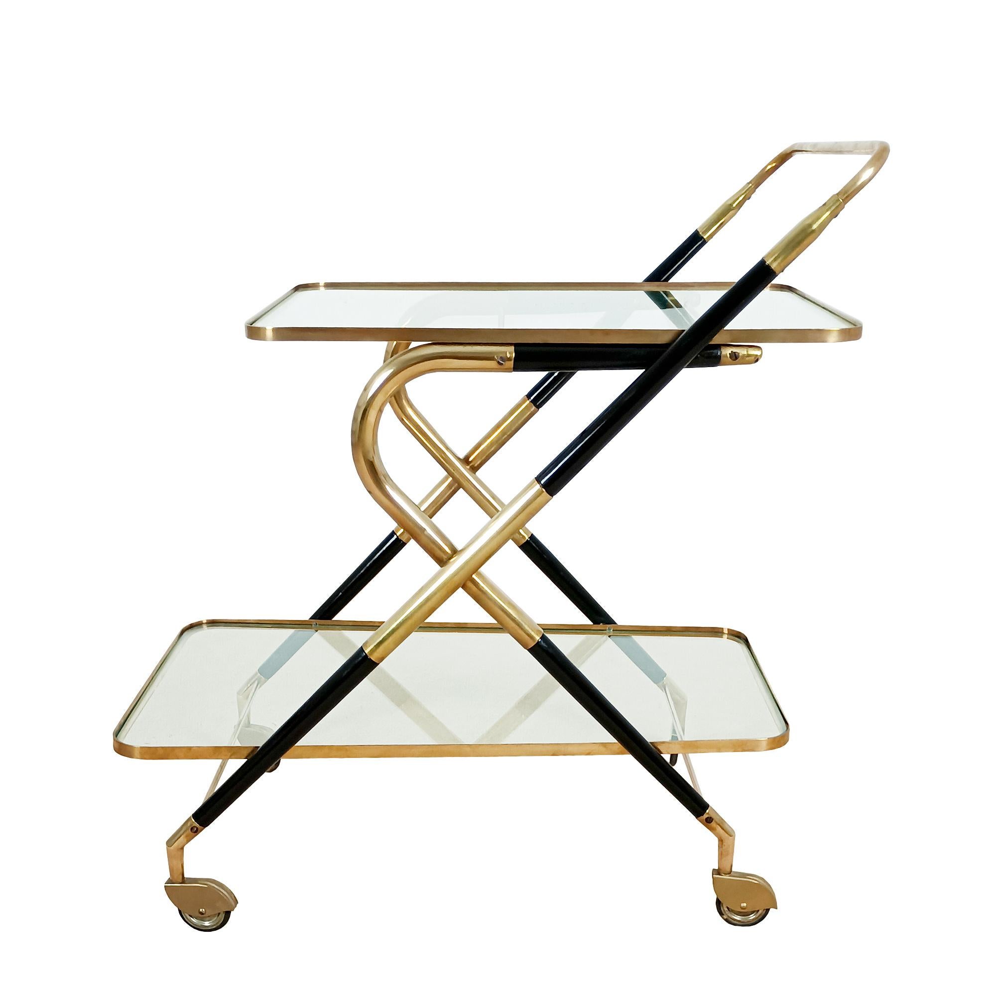 False pair of bar carts (one with bottle holder) in polished brass and stained and french polished beech with original glasses. 
Design: Cesare Lacca.
Italy circa 1950.

Dimensions

cm 73 x 45 x 60/71 (handles)
inches 28.74 x 17.72 x 23.62/27.95