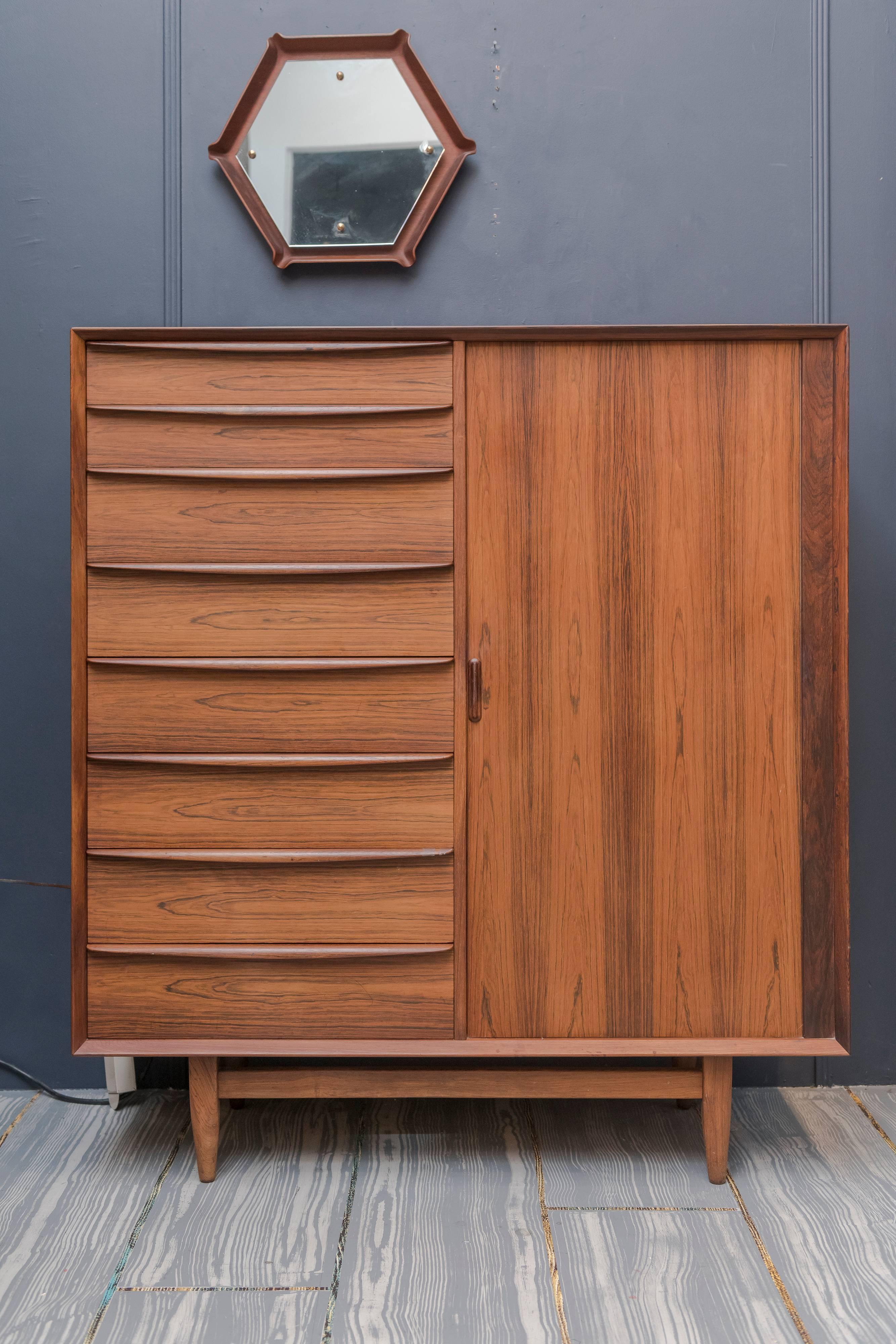 High quality design and construction tall dresser by Falster, Denmark. Comprising eight drawers with a tambor door concealing nine interior drawers. In good vintage condition with age appropriate wear and use.