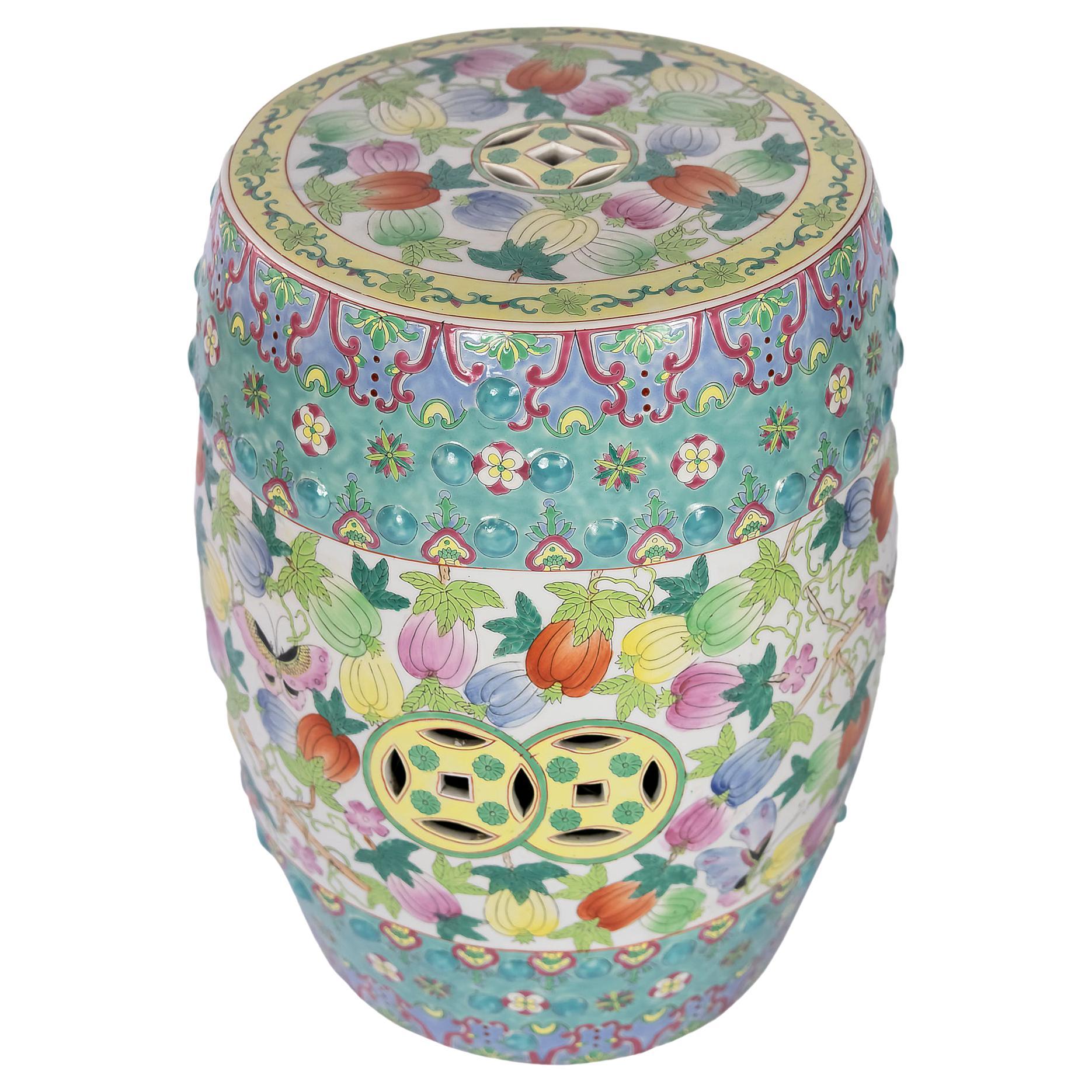Chinese ceramic Famille Rose garden stool with openwork also with glazed circumferential decoration of the floral elements, fruits and butterflies.