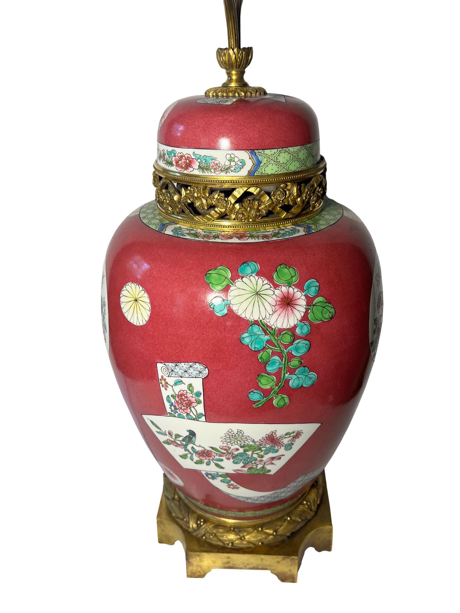 Une superbe lampe en porcelaine de la famille rose du XIXe siècle, ornée de montures en bronze doré de style Louis XVI. Avec des fleurs et des coqs. Deux prises de courant avec chaînes de traction. Le vase lui-même mesure dix-neuf pouces de haut.