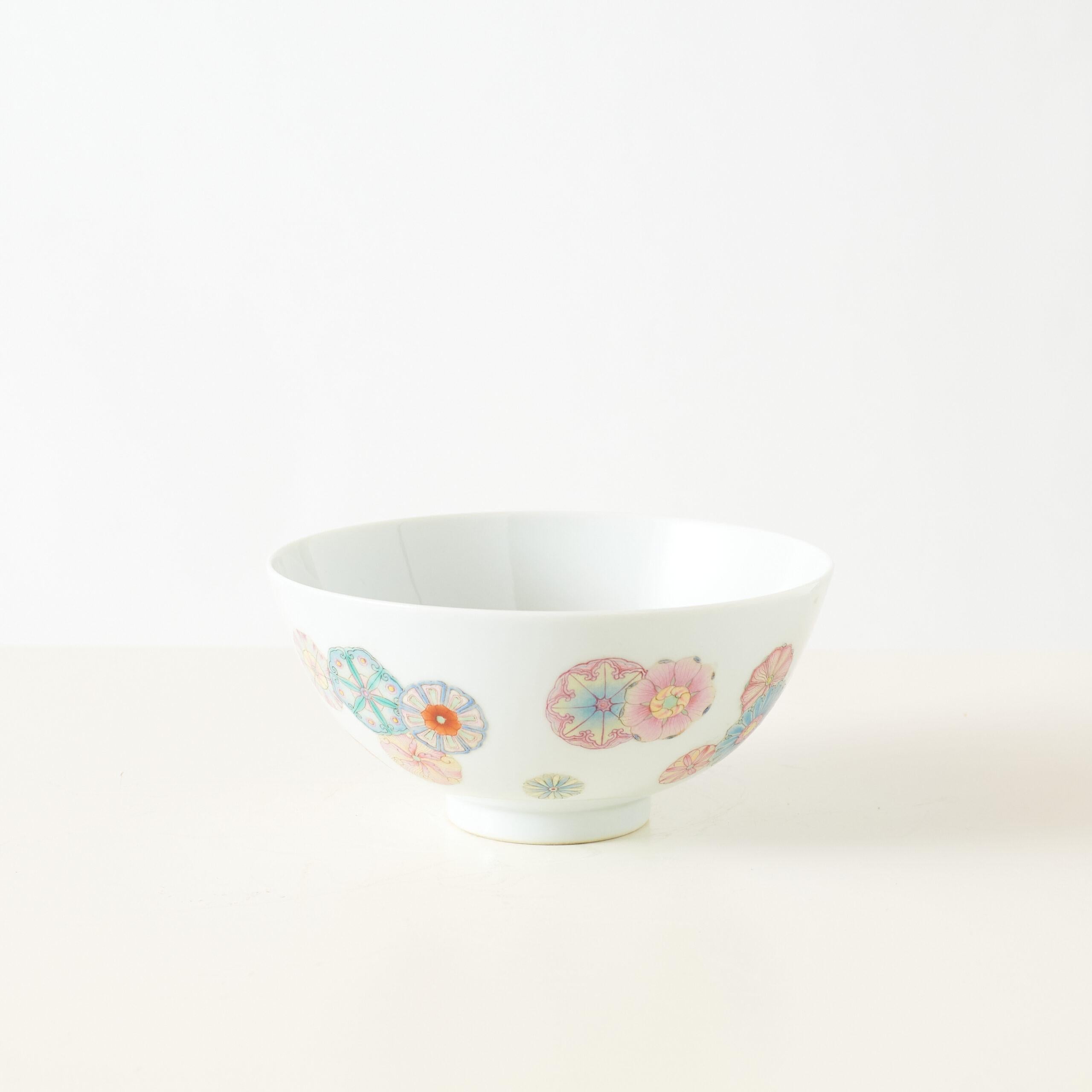 Famille Rose Chrysanthemum Bowl with Yongzheng Mark

Porcelain bowl with delicate floral medallions in vibrant Famille Rose enamels, including shades of pink, blue, yellow, and orange. The rounded form and raised foot reflect classic Qing dynasty