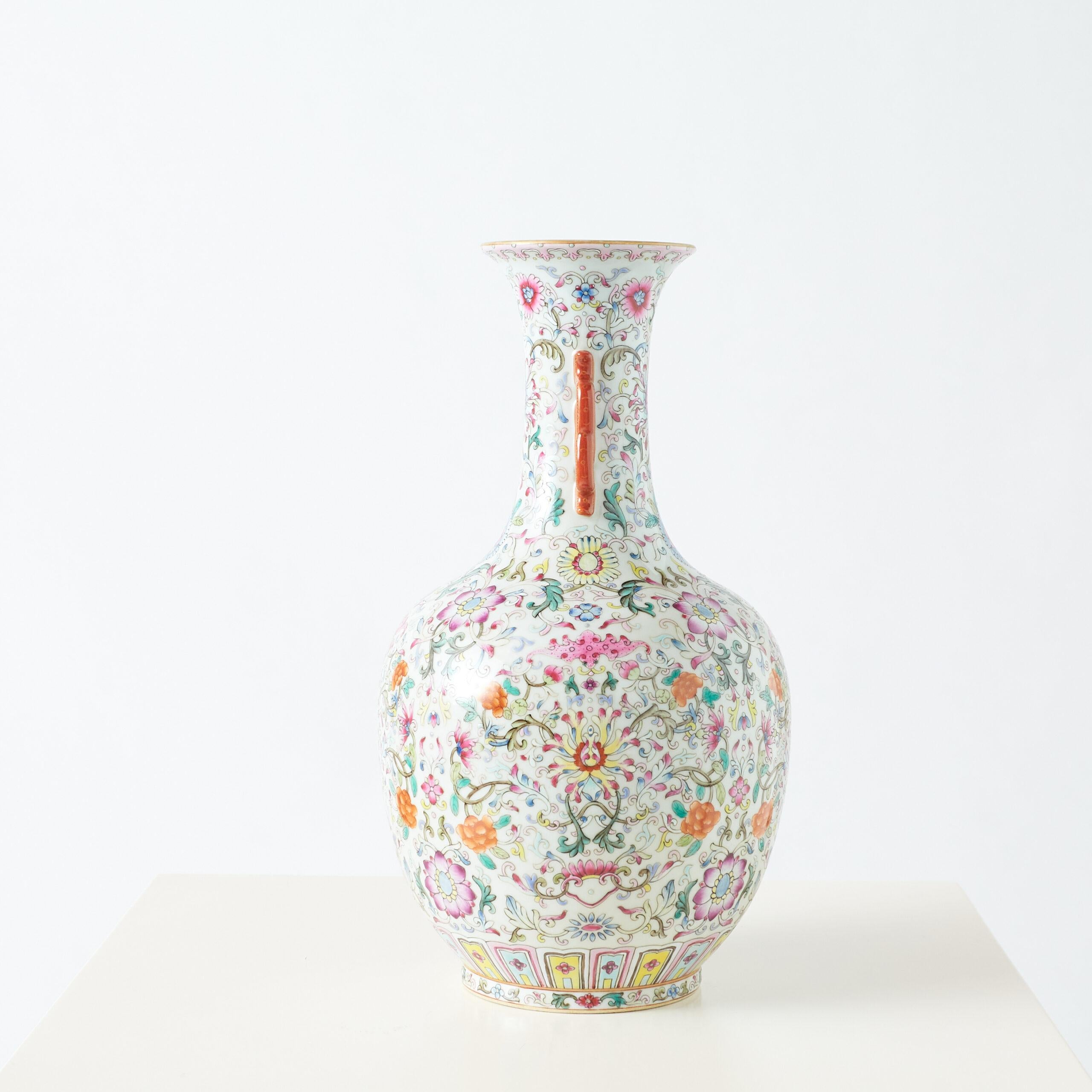 Famille Rose Double-Eared Flower Vase

A highly decorated vase featuring vibrant Famille Rose floral motifs, characterized by delicate pinks, reds, and pastels. The design includes geometric double handles, adding a bold contrast to the soft floral