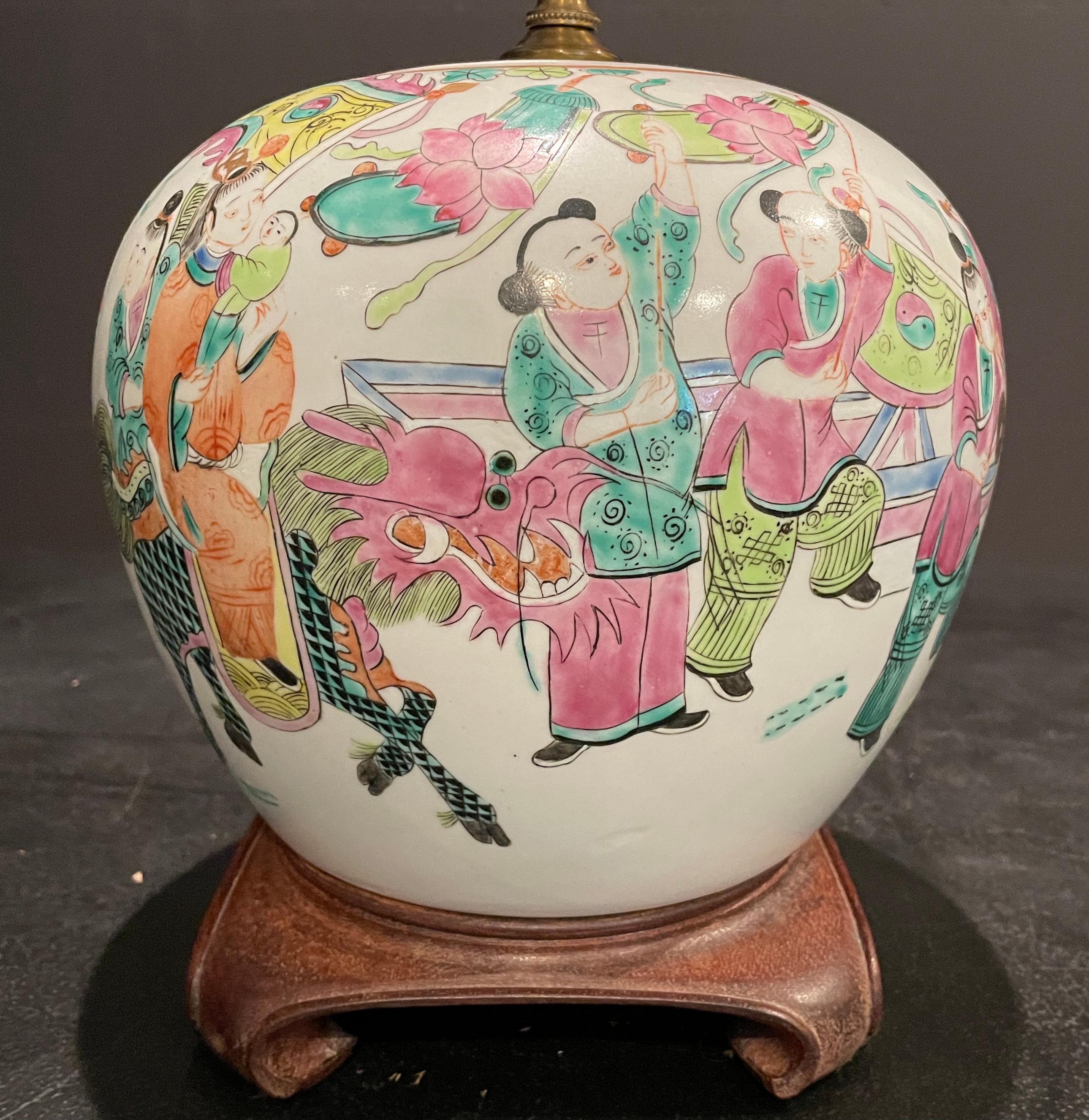 Antique Chinese famille rose porcelain ginger jar mounted as a lamp. Porcelain cover and square wood base. Colorful figures with children and dragon. Orange, pines and greens.
Orange bats at back of vase.
9.5