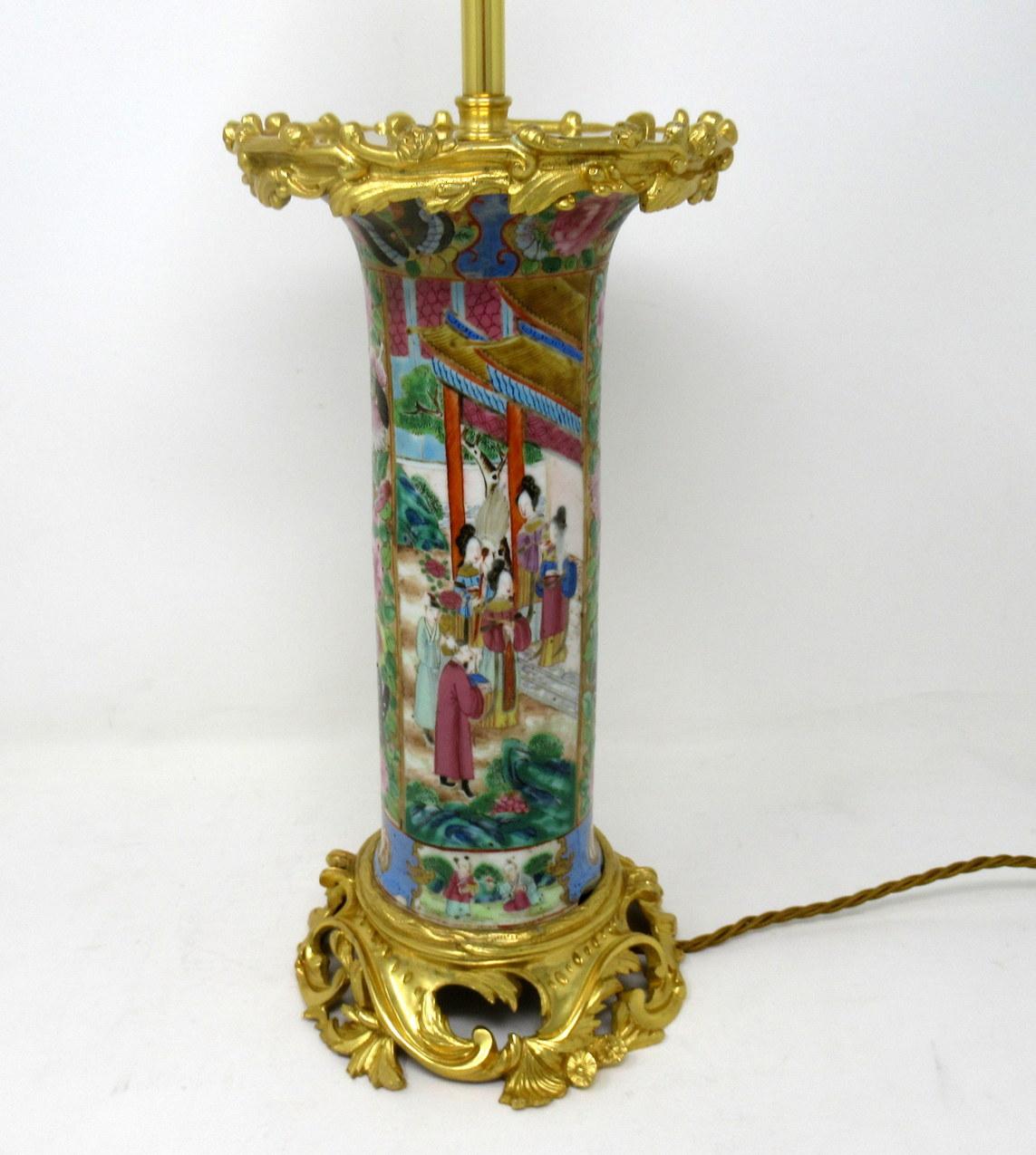 An exceptionally fine example of a Cantonese hand decorated in colors Chinese export porcelain tall cylindrical vase no converted to an electric table lamp of good size proportions, with its original highly ornate mounts and lavish cast rococo style