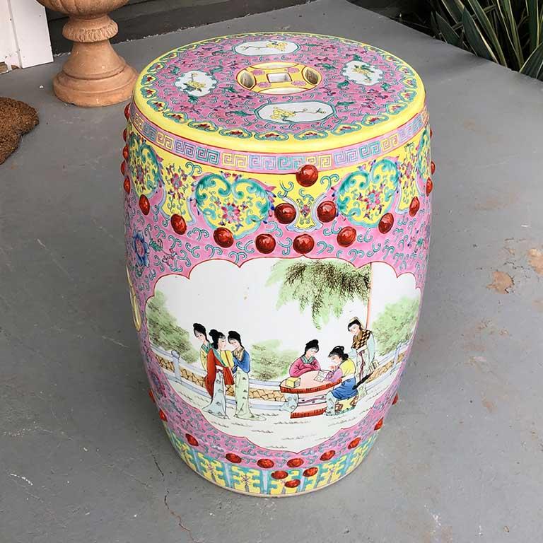 Famille rose bright colorful vintage ceramic garden seat, stool or occasional side table. This ceramic Famille rose pink piece features a ceramic round and oblong body with the overall shape tapering slightly at the top as well as the bottom. The