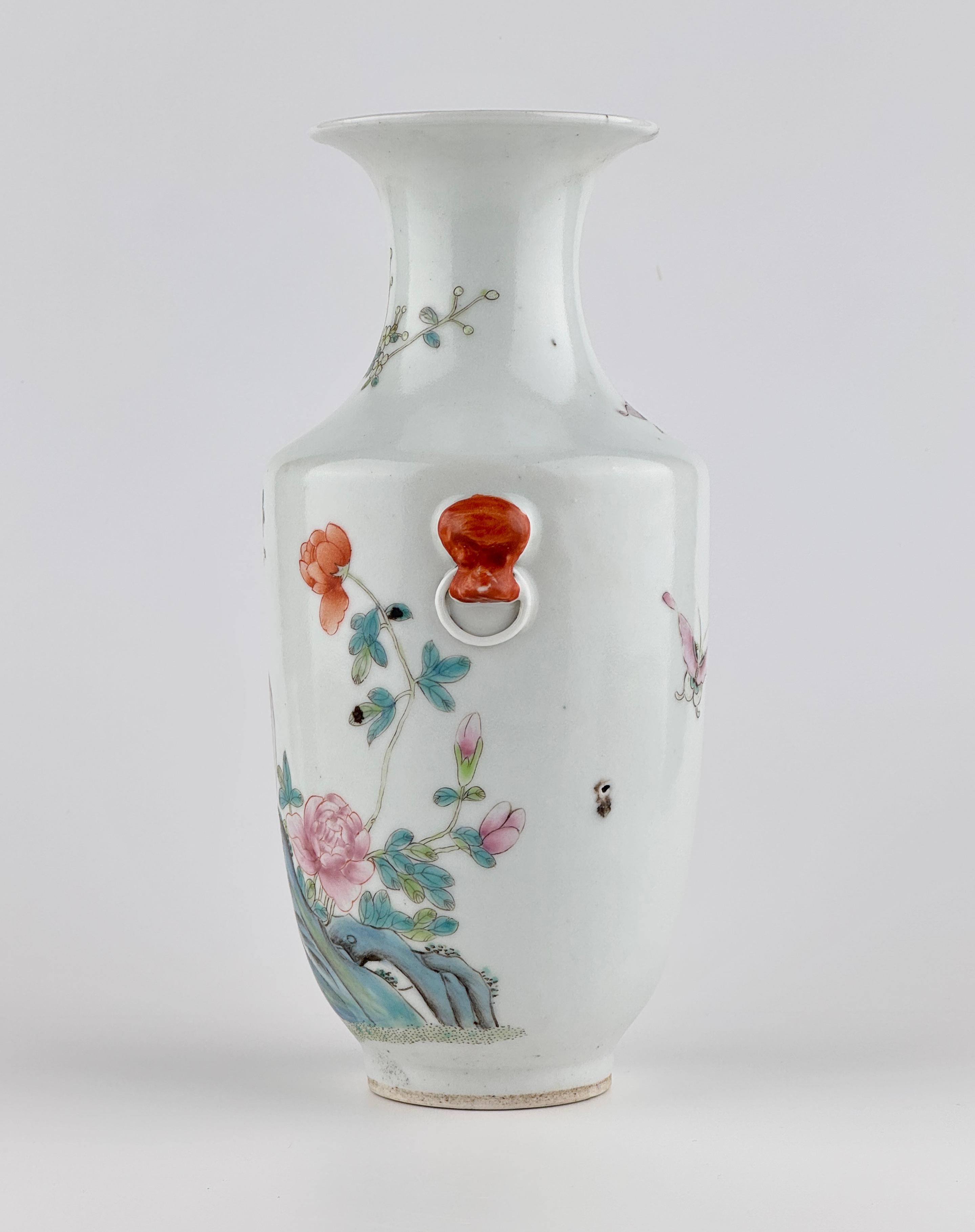 This porcelain vase, likely from the late Qing dynasty or early Republic period (late 19th to early 20th century), is a fine example of Famille-Rose (fencai) decoration. The body is painted with a vividly colored scene of a golden pheasant perched