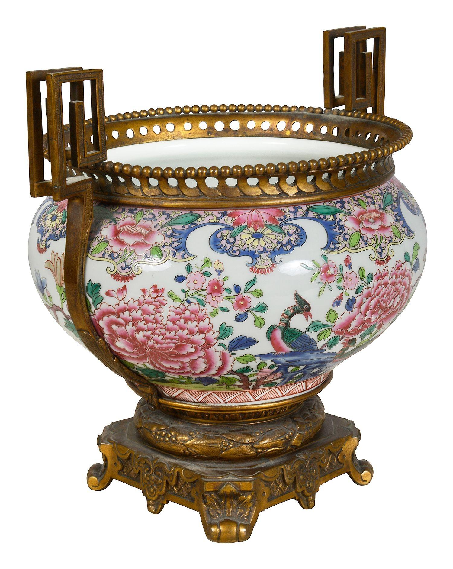 This exquisite late 19th-century jardinière exemplifies the Samson famille rose style, renowned for its vibrant colours and intricate floral motifs. Crafted from fine porcelain, it features a stunning array of peonies and birds, symbolizing beauty