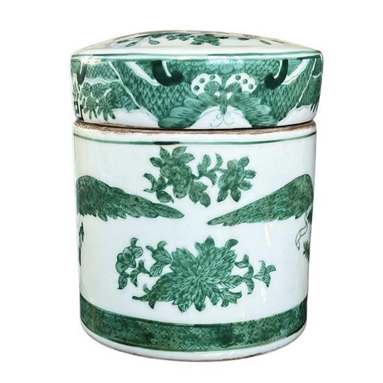 A striking ceramic famille vert Eagle motif tea caddy with lid. This piece is in the Americana or Traditional English style. It is made of crisp white porcelain and is decorated with a rich green hand-painted design. The body features an Eagle with