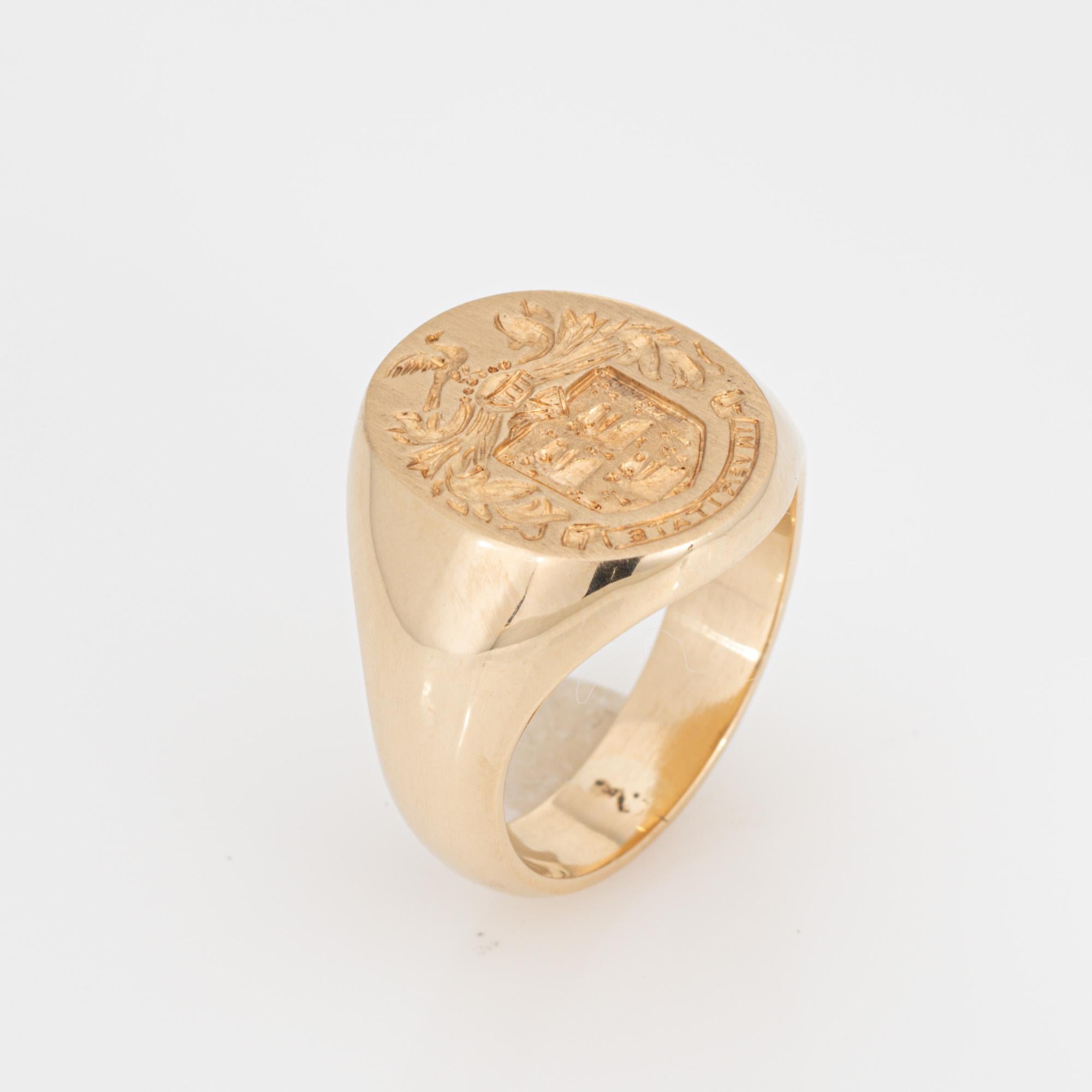 Finely detailed vintage family crest signet ring (circa 1950s to 1960s) crafted in 14 karat yellow gold. 

The signet ring weighs a hefty 16.1 grams and has a solid feel on the finger. The signet mount features a wreath framing three Bears. A bird