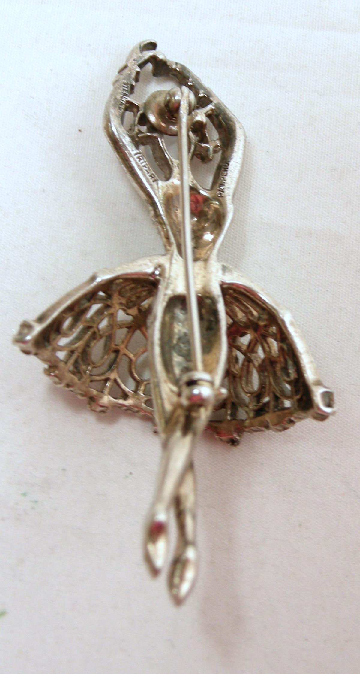 This is the famous Trifari Ballerina brooch made in the 1940s.  Her face is a faux moonstone and she’s wearing a sterling silver gold vermeil ballerina tutu with red and clear crystals.  In excellent condition, this brooch measures 2-1/2” x 1-1/4”