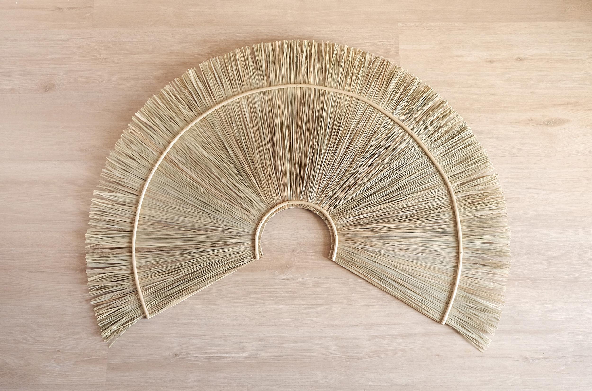 Organic Modern Figurative Wall Fan handcrafted in Spain by Gabriela de Sagarminaga. It was crafted based on the an spanish cultural object: the fan. Made with esparto grass and topped with pith on a birch wooden base, this art piece presents
