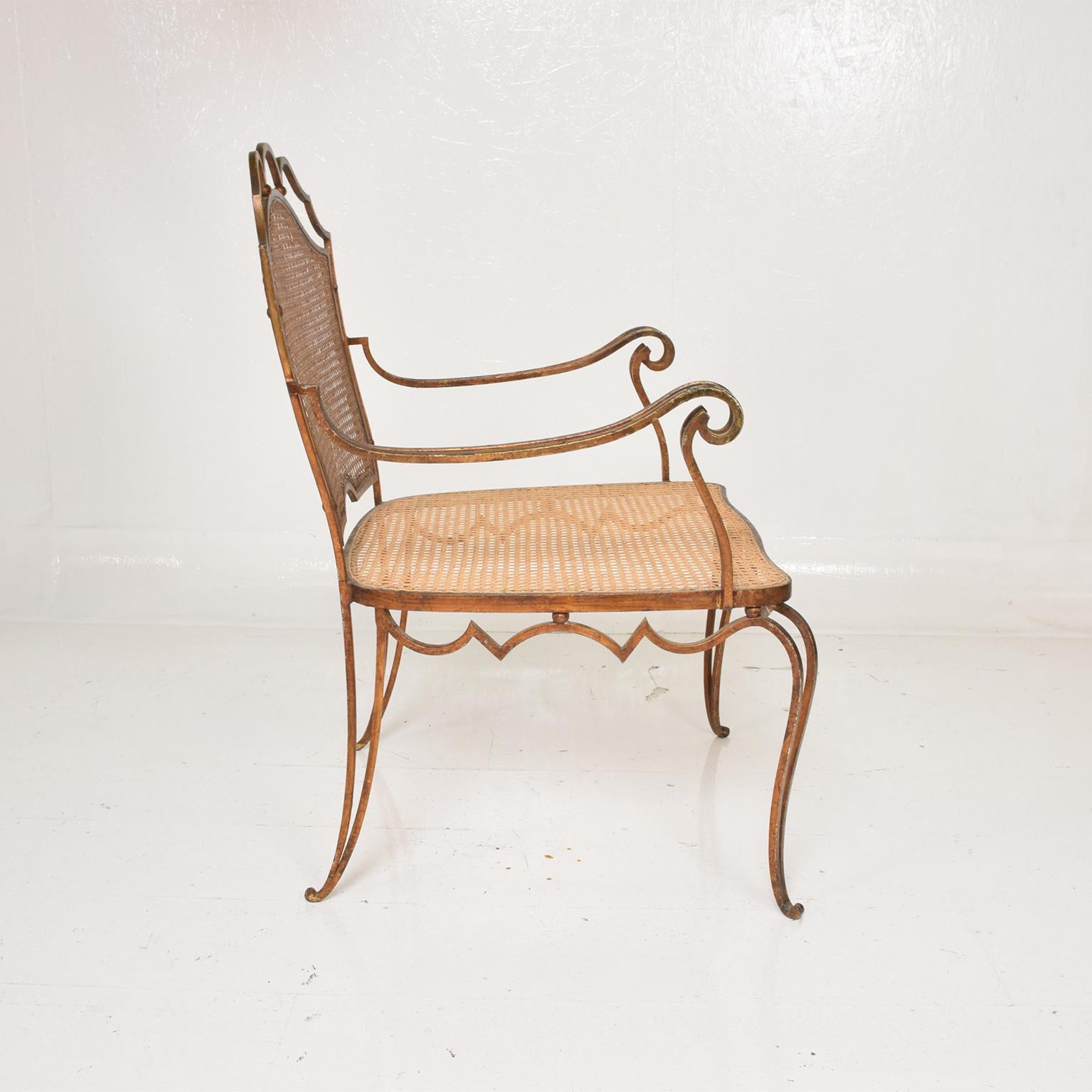 Elegant Regency armchair by Arturo Pani (famed Mexican Modernist) Mexico City, circa 1948 early 1950s Mexican Modernism at its finest.
Chair designed in forged iron with gold leaf finish handwoven cane wicker seat and backrest
Chairs present