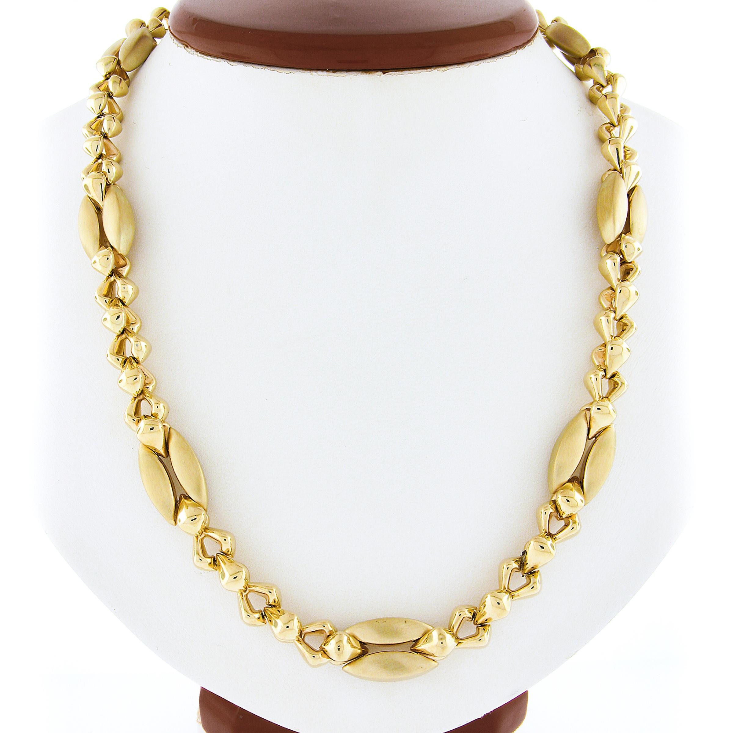 This long and fancy Italian made chain/necklace is very well crafted in solid 14k yellow gold and features a beautiful design that is constructed from links that alternate with a high polished and brushed finish sections throughout. The wonderful