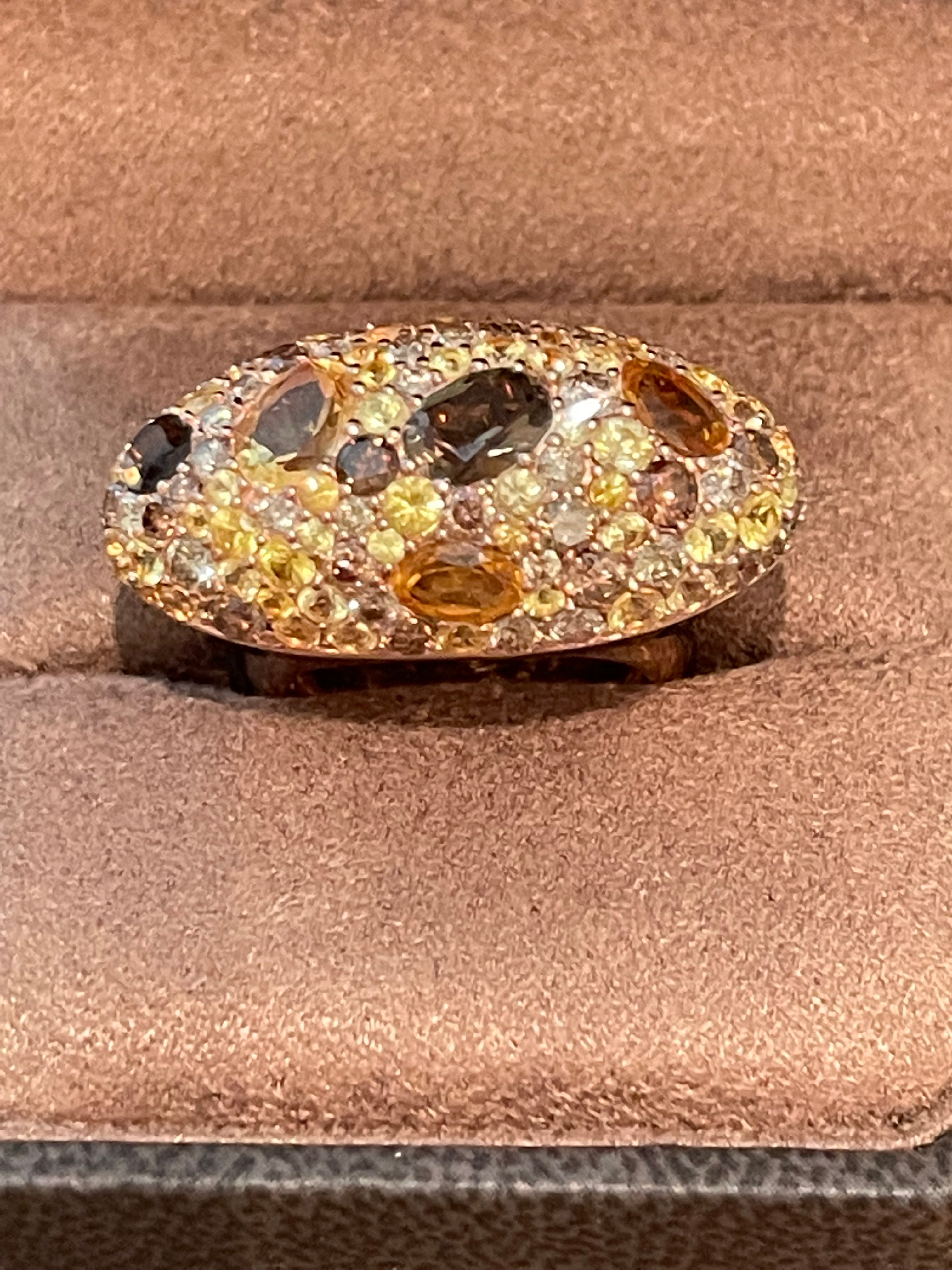 Stunning 18 K rose Gold Statement Ring featuring pave set Champagne Diamonds, yellow Sapphires, Citrines and Smoky Quarz. Lovely and warm color combination. The 61 brilliant cut Champagne Diamonds have a total weight of 3.06 ct. 18.39 grams.