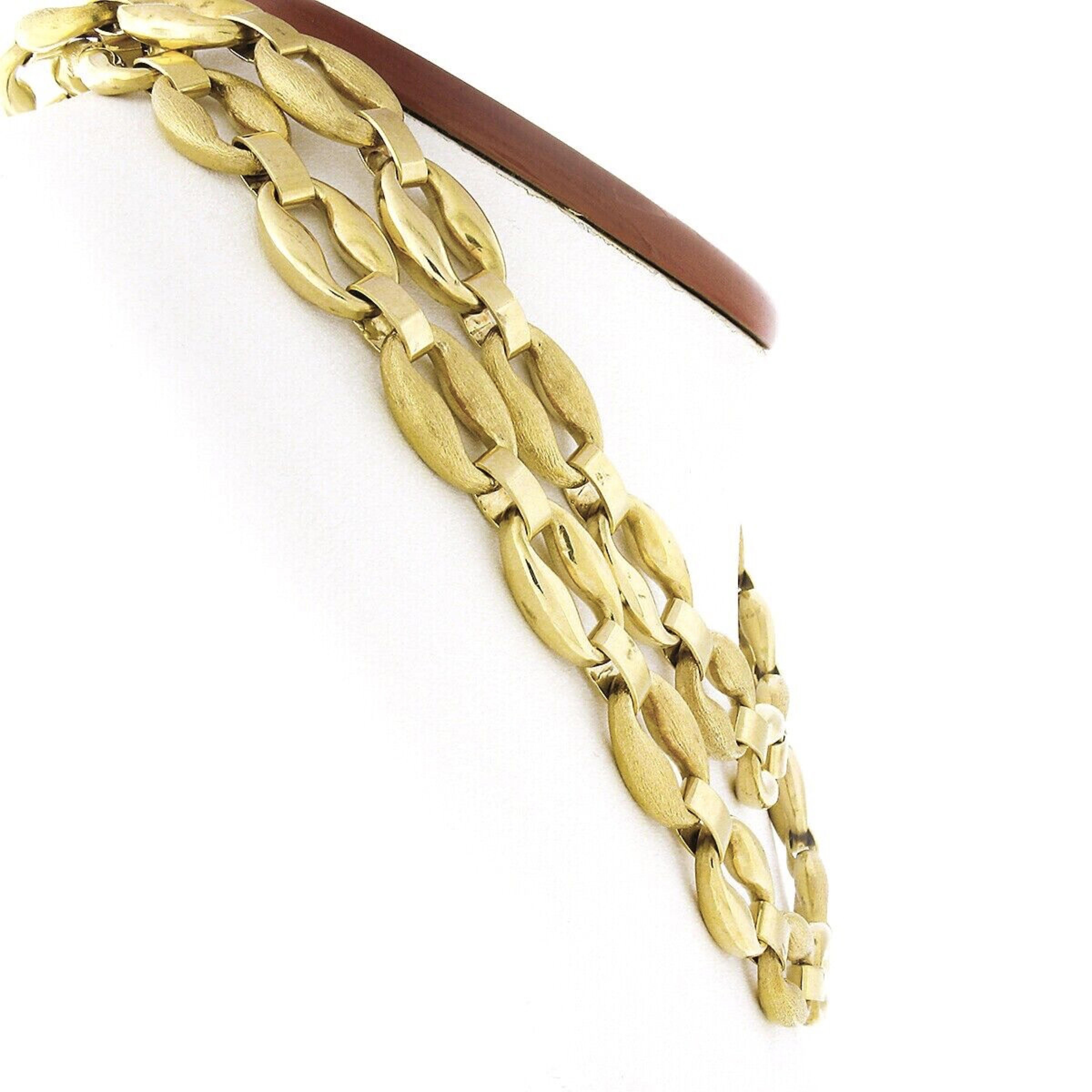 This long and fancy chain necklace is very well crafted in solid 18k yellow gold and features a beautiful design that is constructed from large oval links that alternate with a high polished and brushed finish entirely throughout one side of the