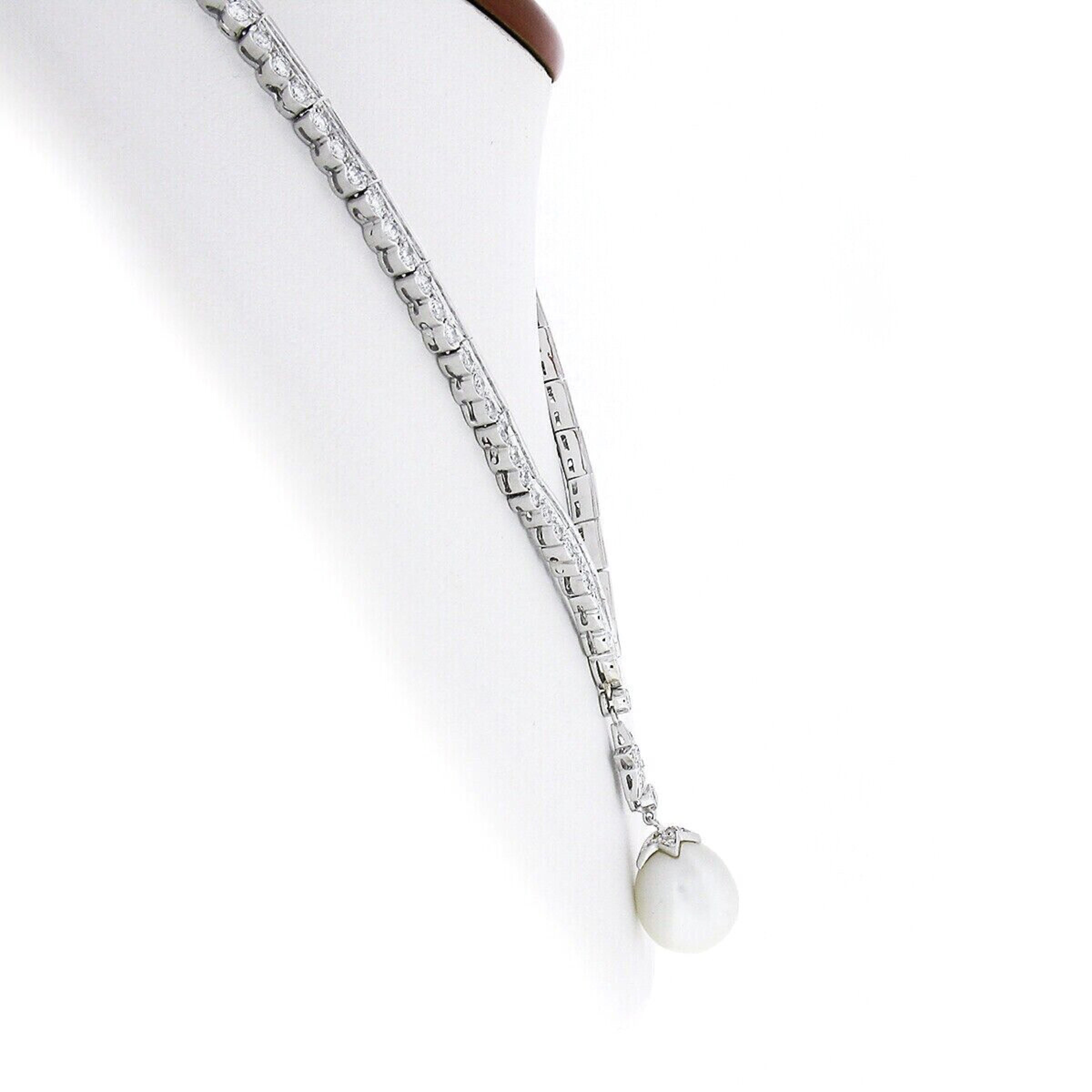 This magnificent and fancy chevron necklace is crafted from solid 18k white gold. It is constructed from very well made scalloped edge links throughout and features a gorgeous diamond covered star link and large cultured pearl pendant that gently