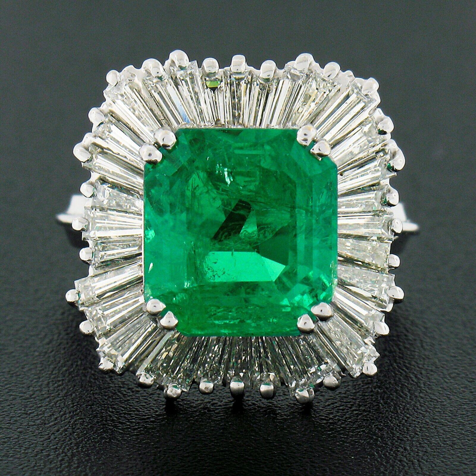 You are looking at a MAGICAL emerald and diamond ballerina-style fancy cocktail ring crafted in solid 18k white gold and featuring a large, approximately 5.92 carats emerald cut genuine emerald stone prong set at the center of the ring and is AGL