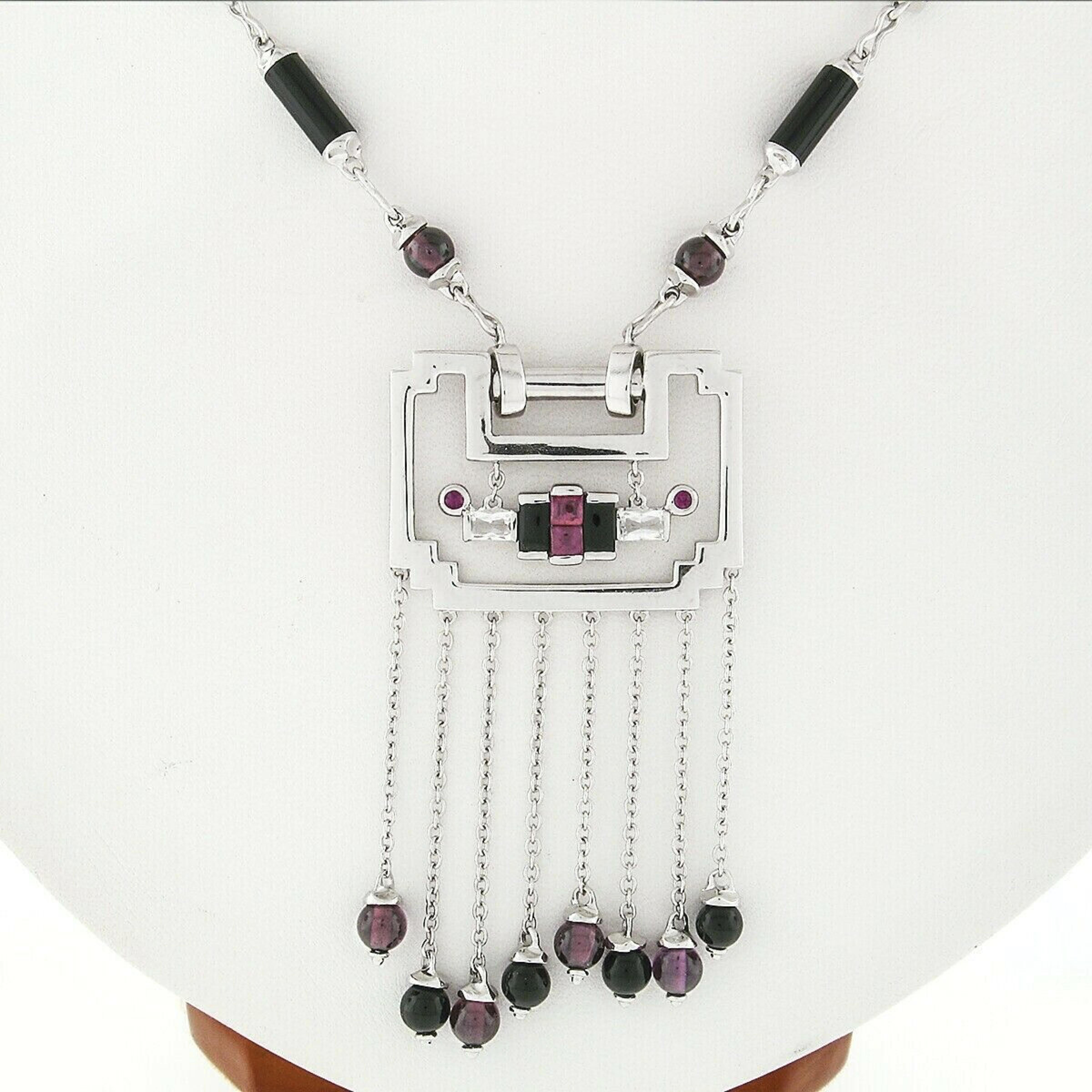Here we have a stunning fancy tassel/chandelier pendant necklace crafted from solid 18k white gold. It features alternating cylinder black onyx and beaded purplish red tourmaline stones that beautifully adorn the 20 inches chain throughout. The