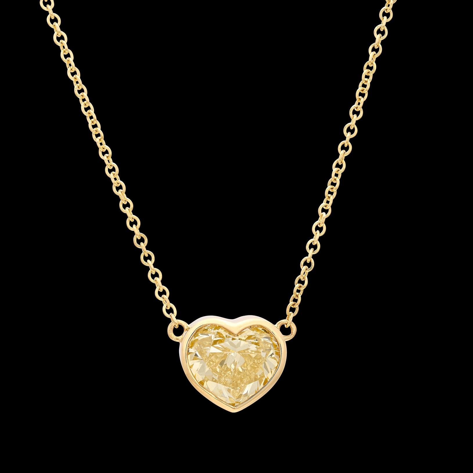A symbol of true love! This 18k gold solitaire pendant-necklace features a bezel-set heart-shaped weighing 2.0 carats, yellow color and SI clarity, completed with a delicate chain. The weighs 4.4 grams, and is designed to be worn either at 16 or 18