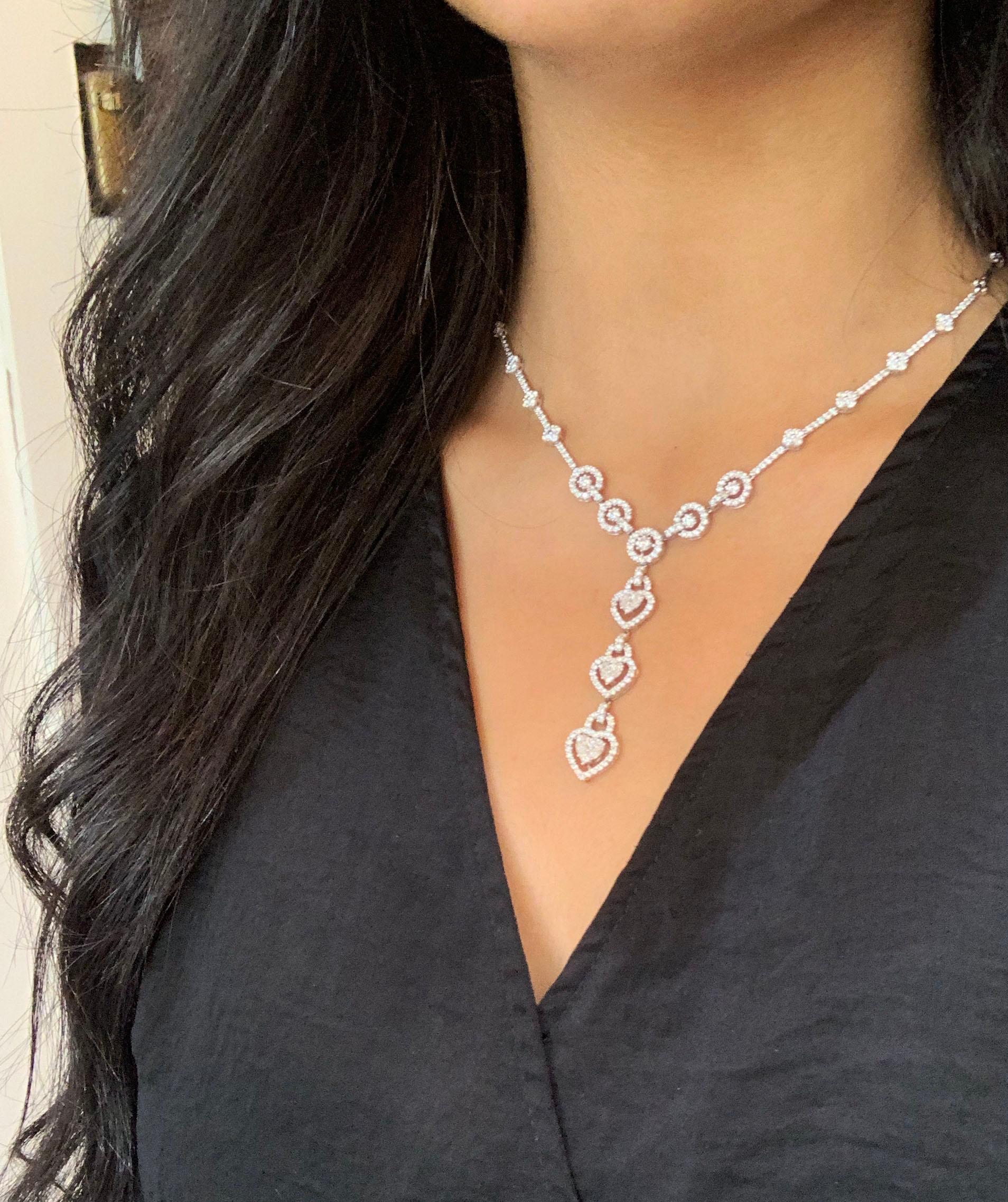 Elegant heart drop necklace set with 257 diamonds totalling to 8.38 carats beautifully claw set in 18 carat white gold. Predominantly set with fine round brilliant cut diamonds, each of the three hearts are fitted with two pear shaped diamonds and a